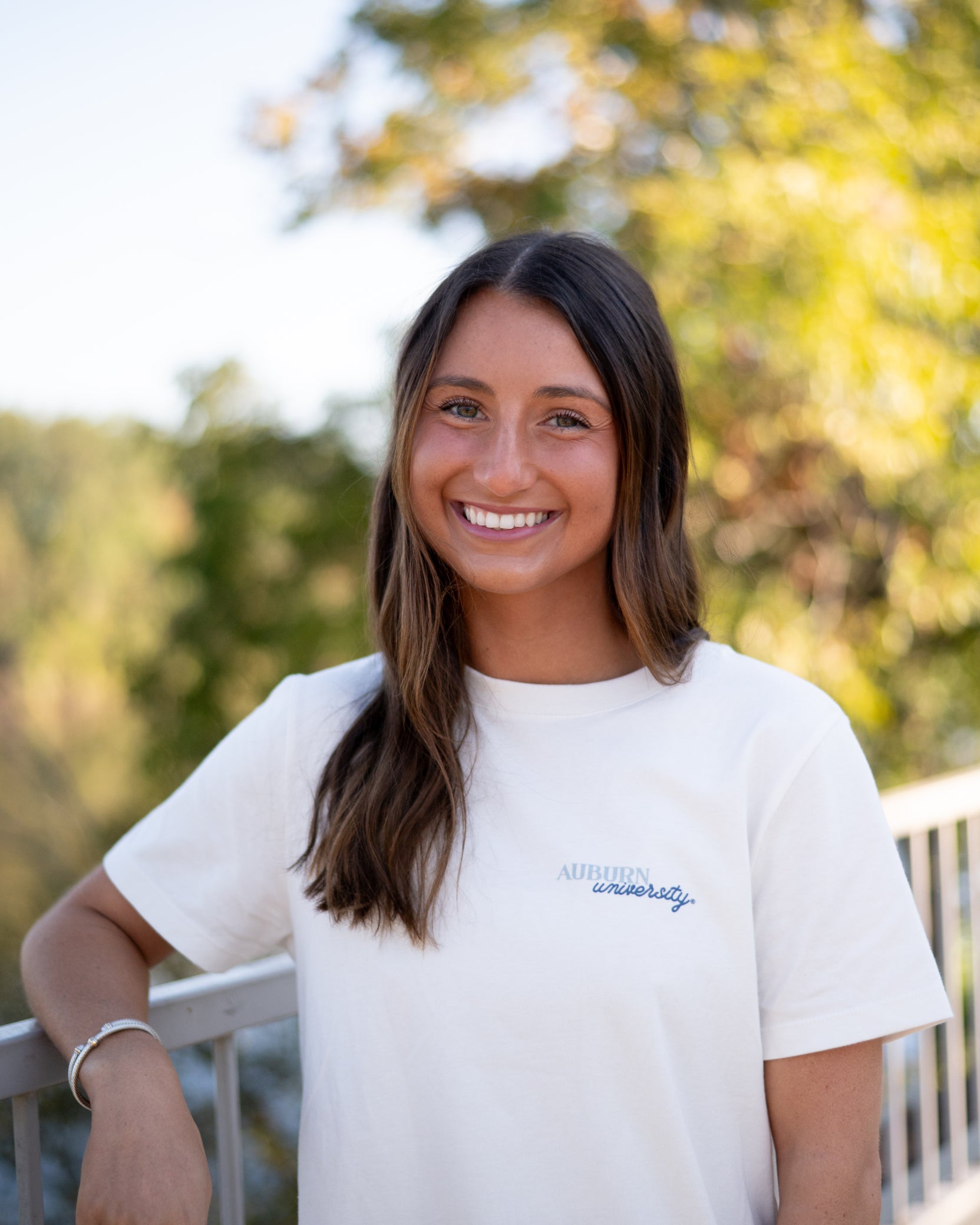 Auburn University White Ladies Tee with a vintage Blue illustration of cowgirl boots with bows tied on them above Blue text “Home On The Plains”
