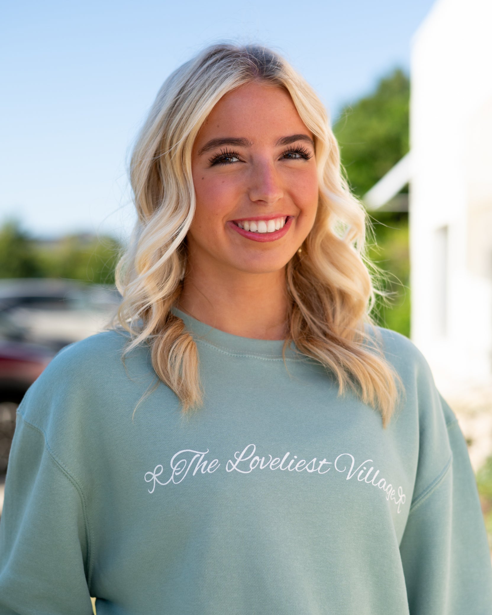 Auburn University Seafoam Crewneck with cursive writing on the front and an open locket with the writing “WDE” inside on the back