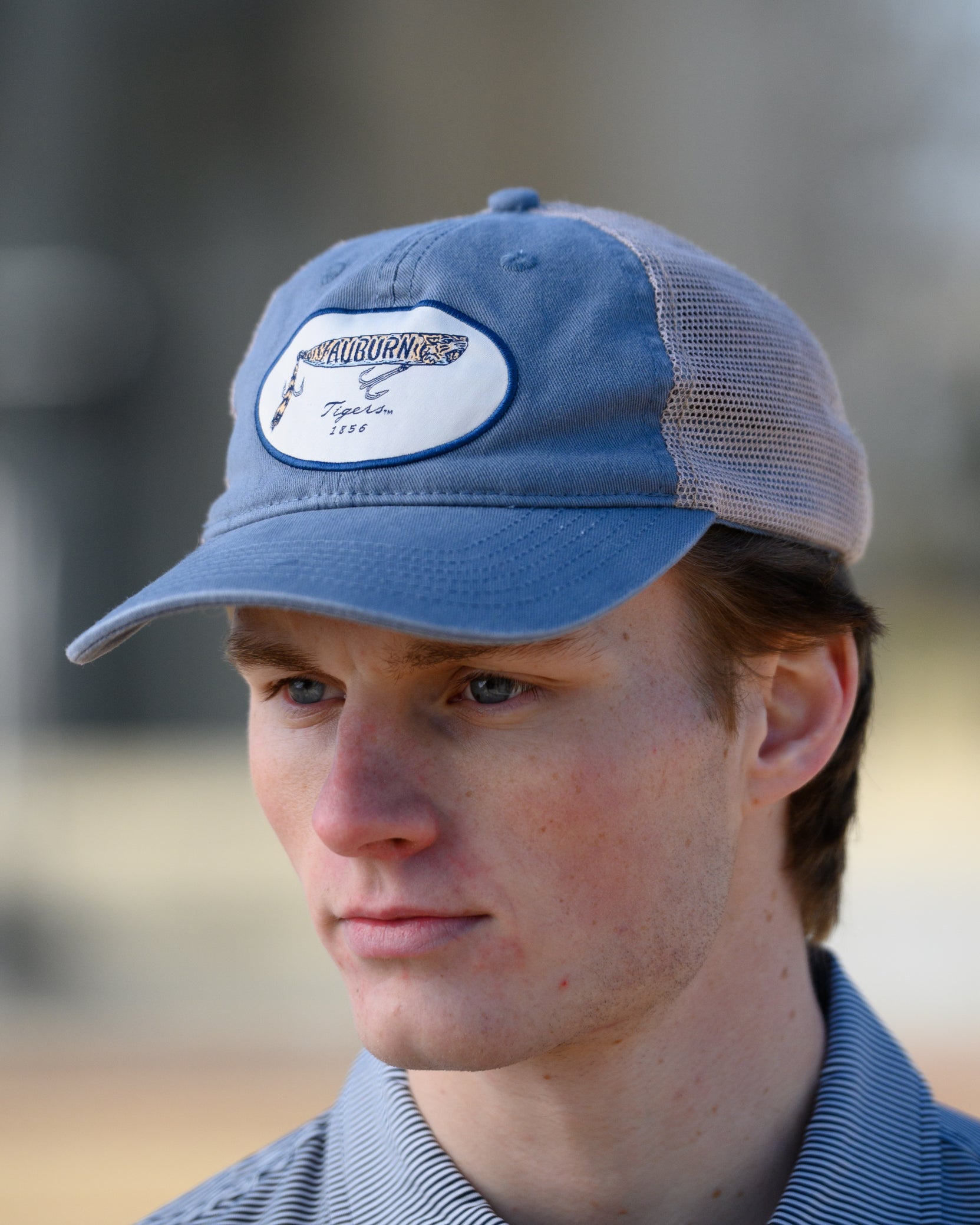 Auburn University Dusty Navy Hat featuring a patch with a tiger fishing lure with the Blue text “Auburn”