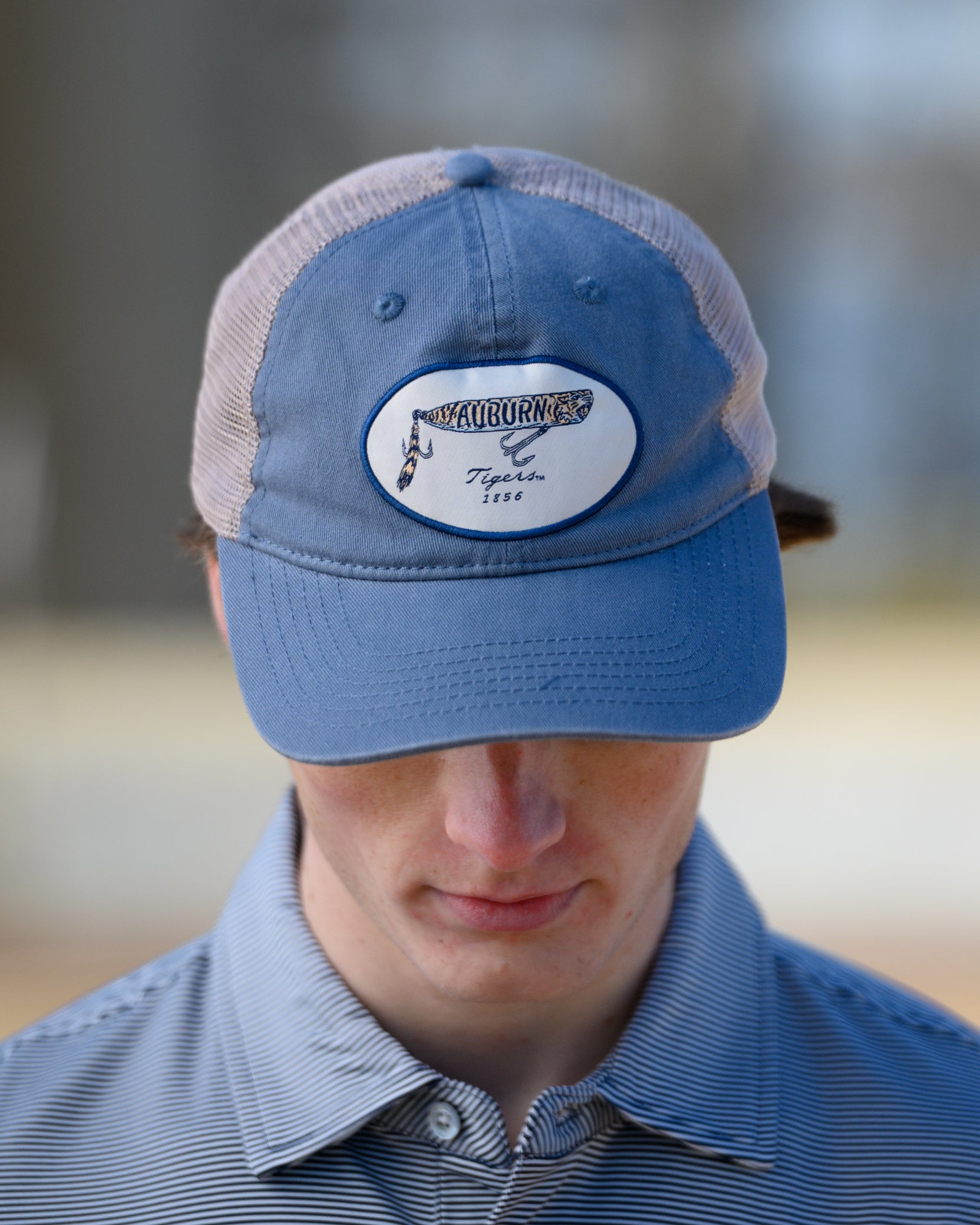 Auburn University Dusty Navy Hat featuring a patch with a tiger fishing lure with the Blue text “Auburn”