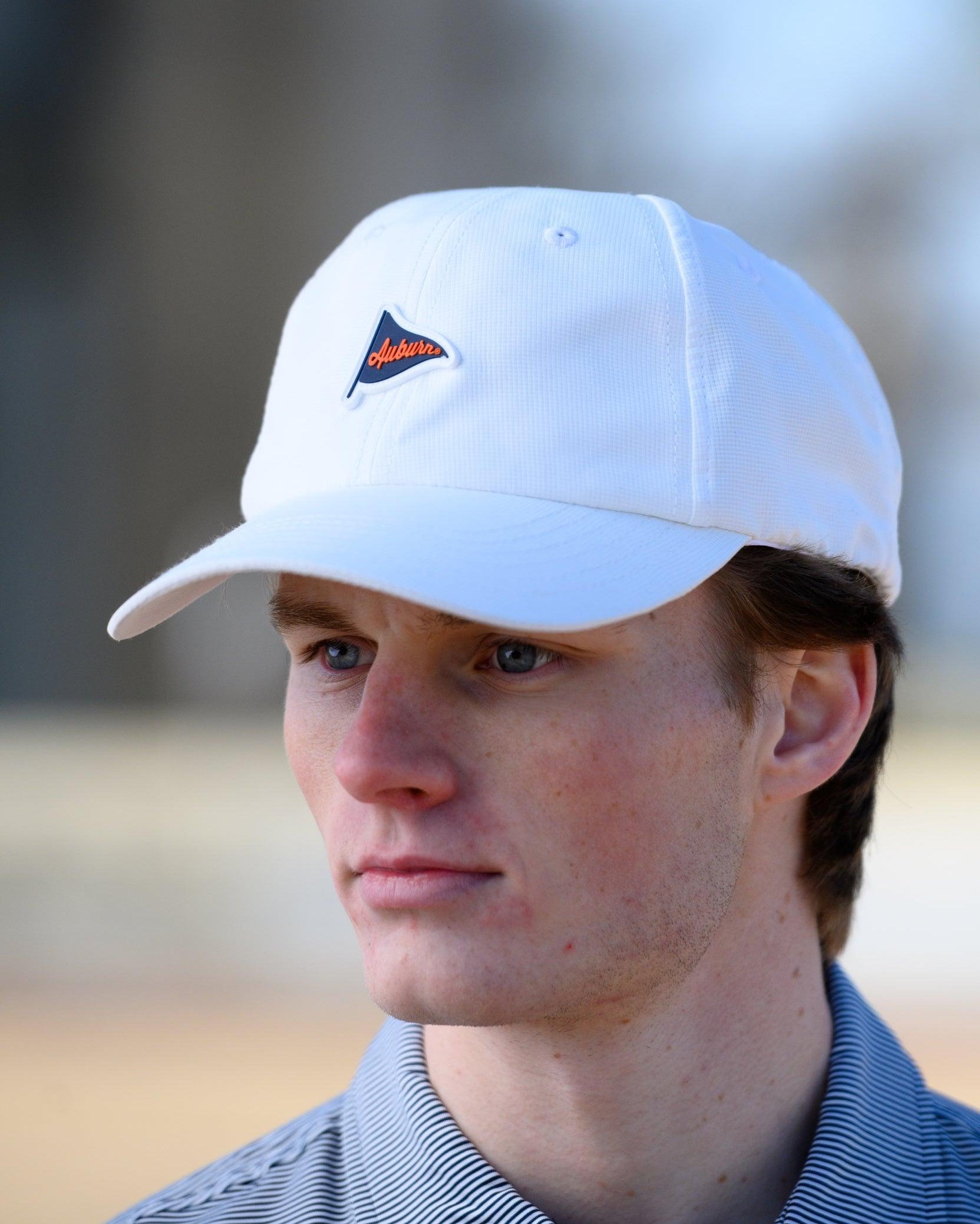 Auburn University White Hat featuring a Navy pennant flag patch with Orange script “Auburn”