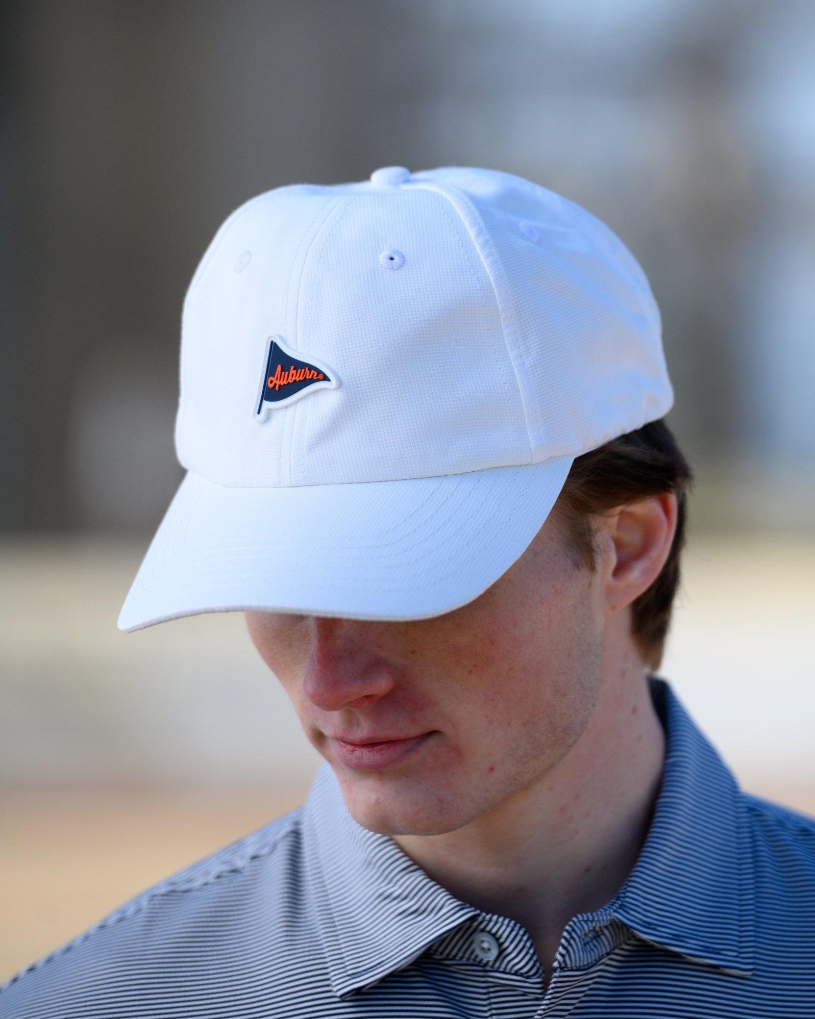 Auburn University White Hat featuring a Navy pennant flag patch with Orange script “Auburn”