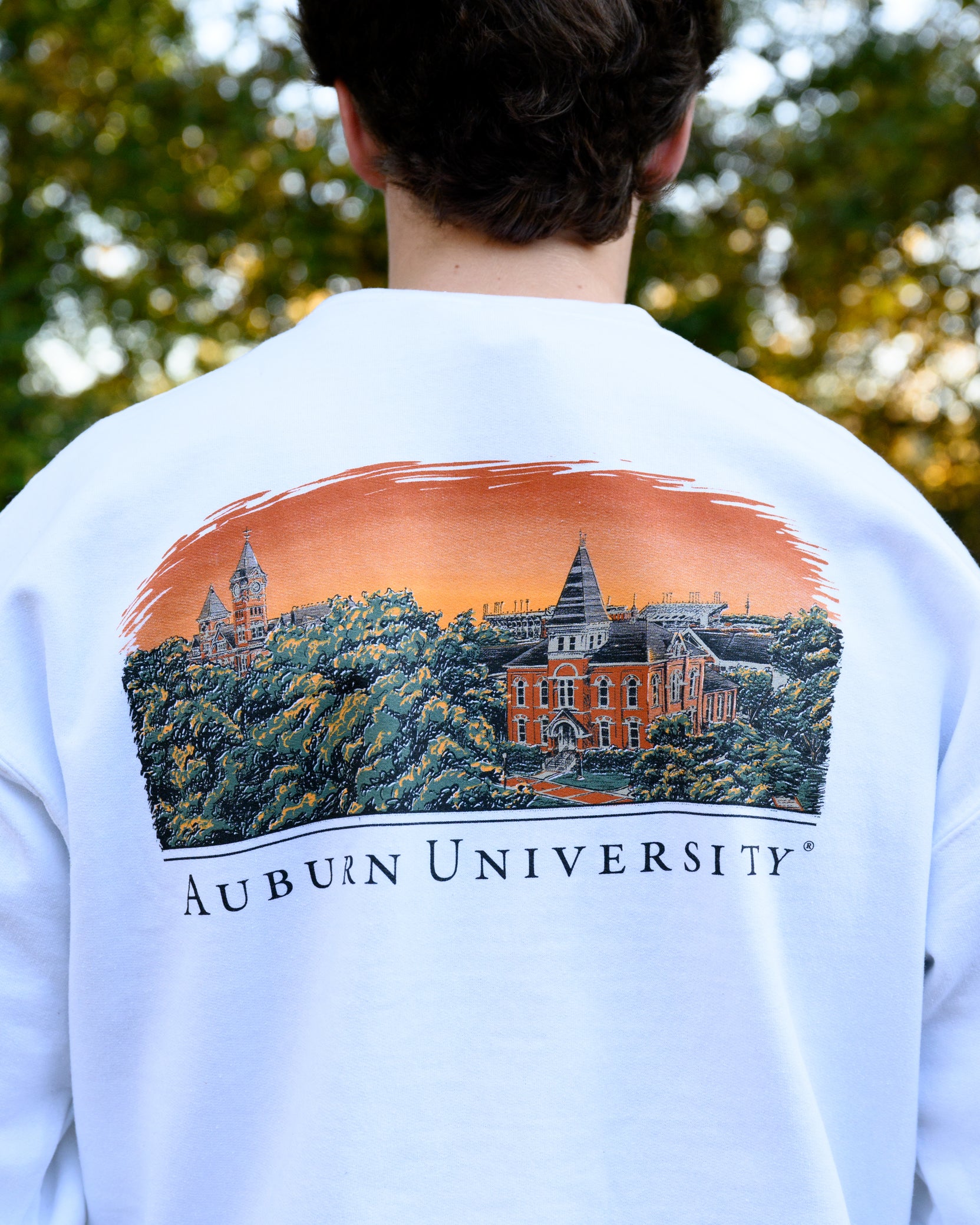 Auburn University Auburn Skyline  White Gildan Sweatshirt with an image of a sun setting on the University above text "Auburn University"