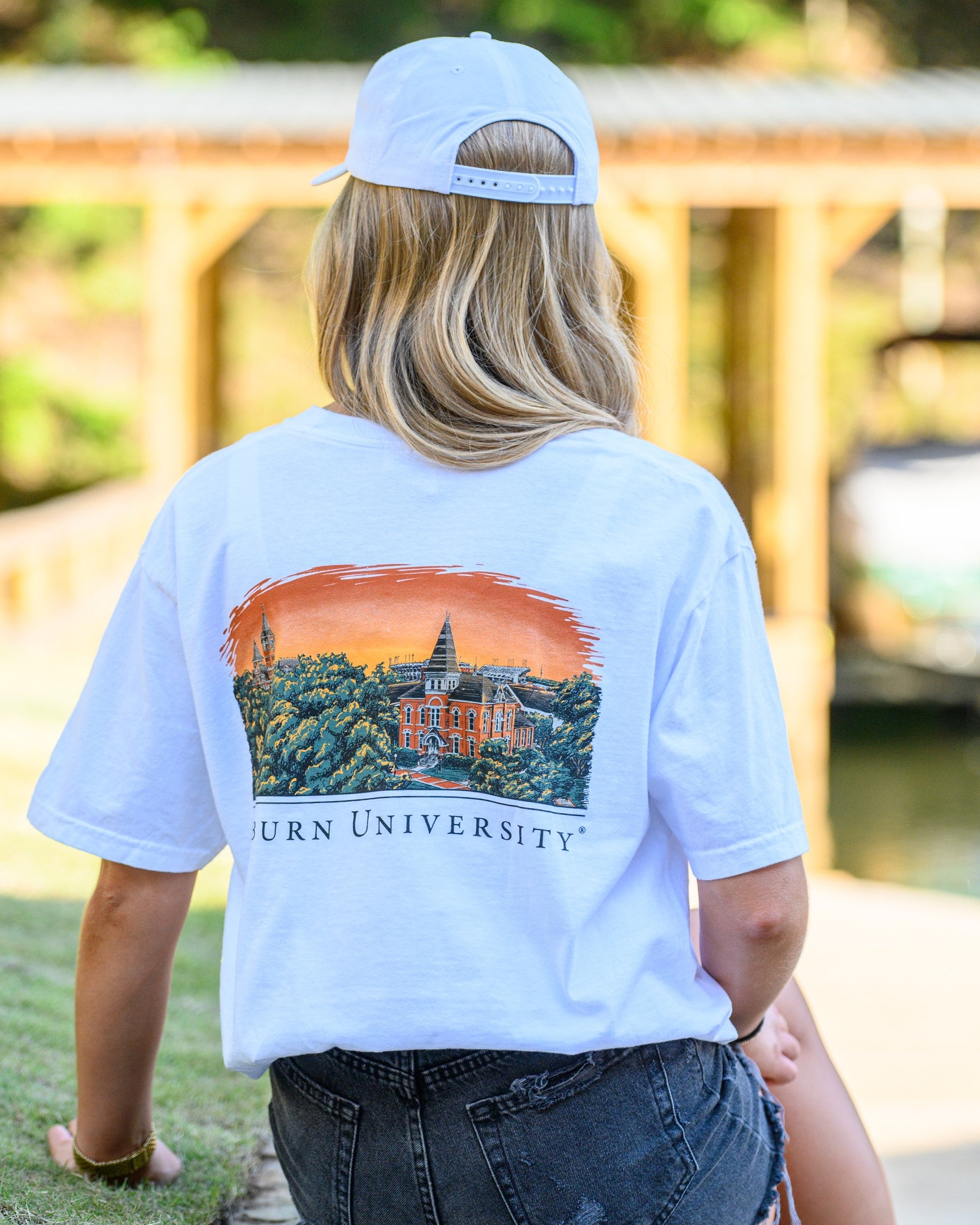 Auburn University Auburn Skyline White Comfort Colors T-Shirt with an image of a sun setting on the University above text "Auburn University"
