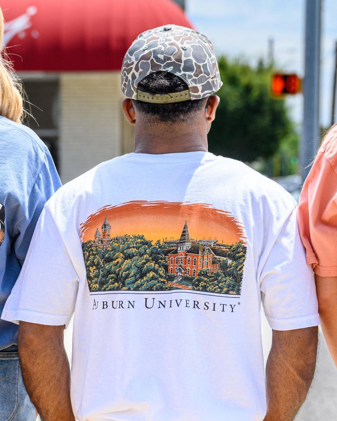 Auburn University Auburn Skyline White Comfort Colors T-Shirt with an image of a sun setting on the University above text "Auburn University"