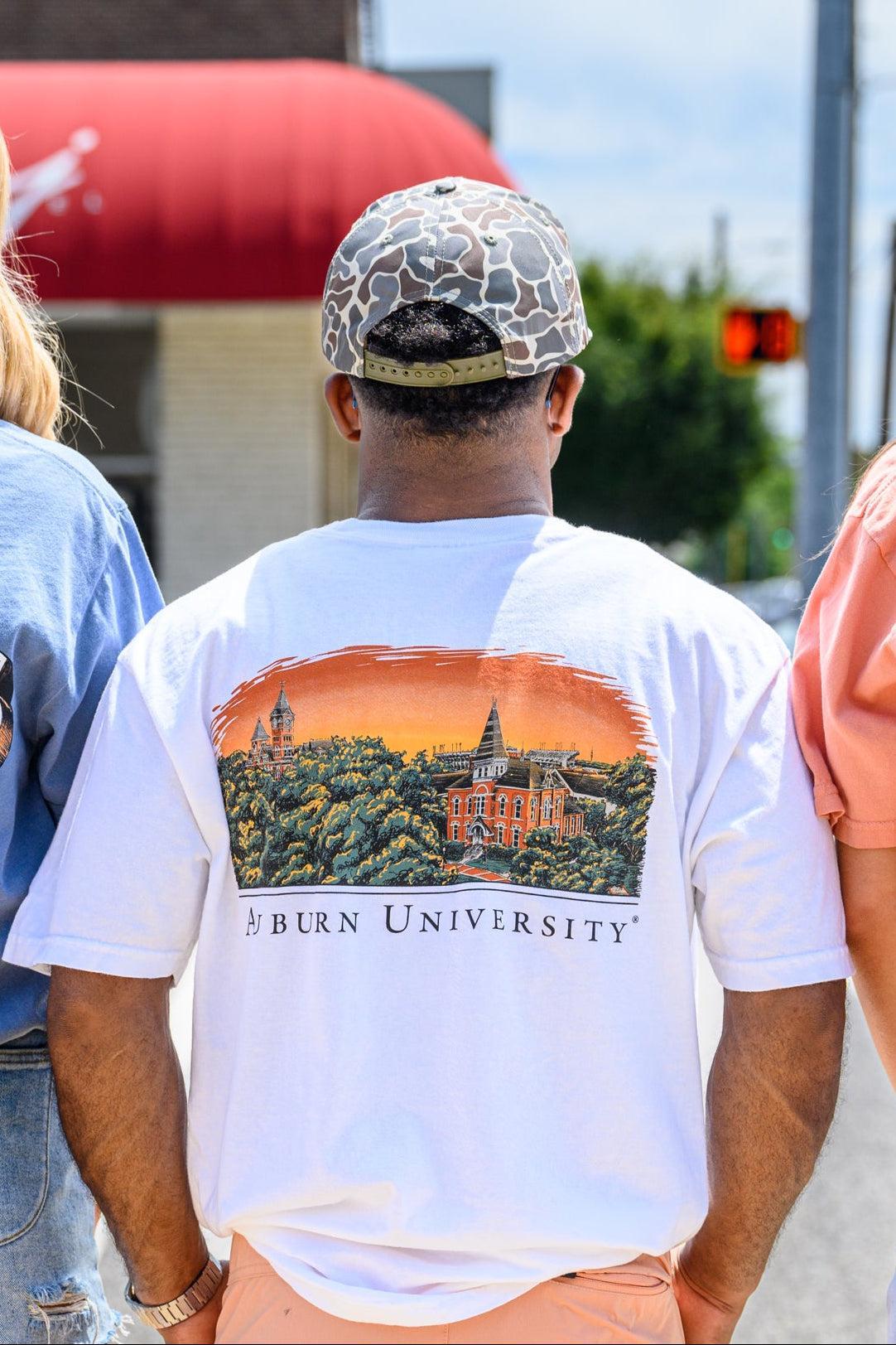 Auburn University Auburn Skyline White Comfort Colors T-Shirt with an image of a sun setting on the University above text "Auburn University"