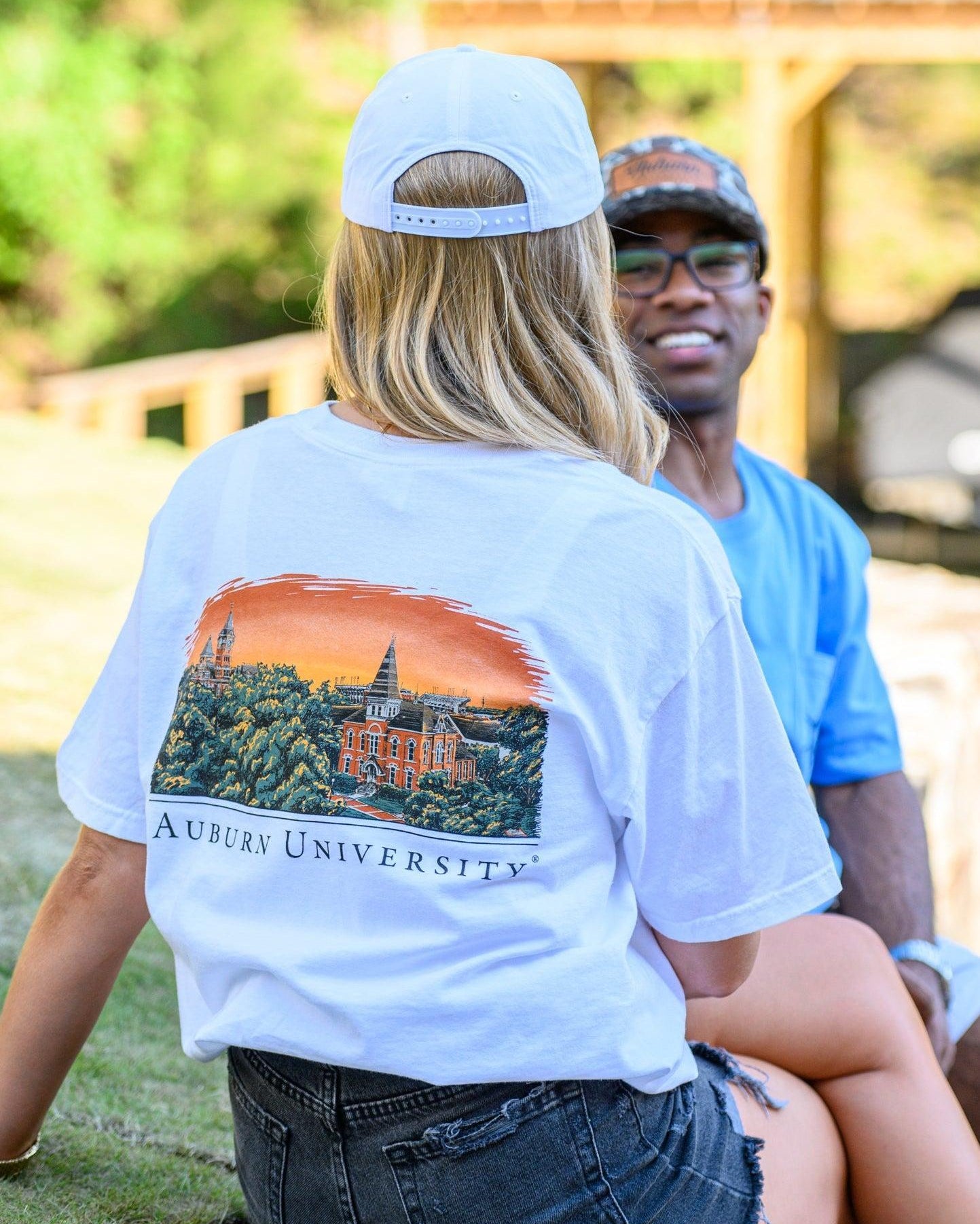 Auburn University Auburn Skyline White Comfort Colors T-Shirt with an image of a sun setting on the University above text "Auburn University"