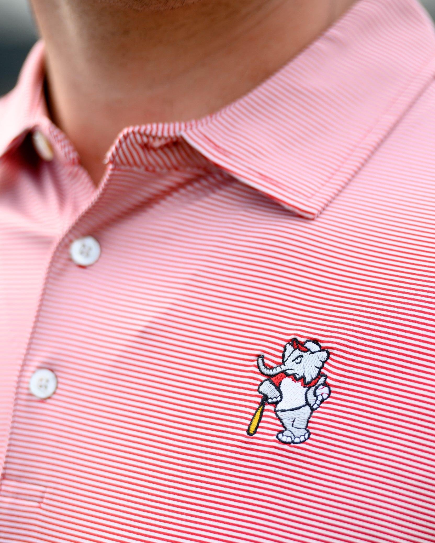 University of Alabama Men's Crimson Stripe Performance Polo with an embroidered image of Big Al in a baseball uniform leaning on a baseball bat