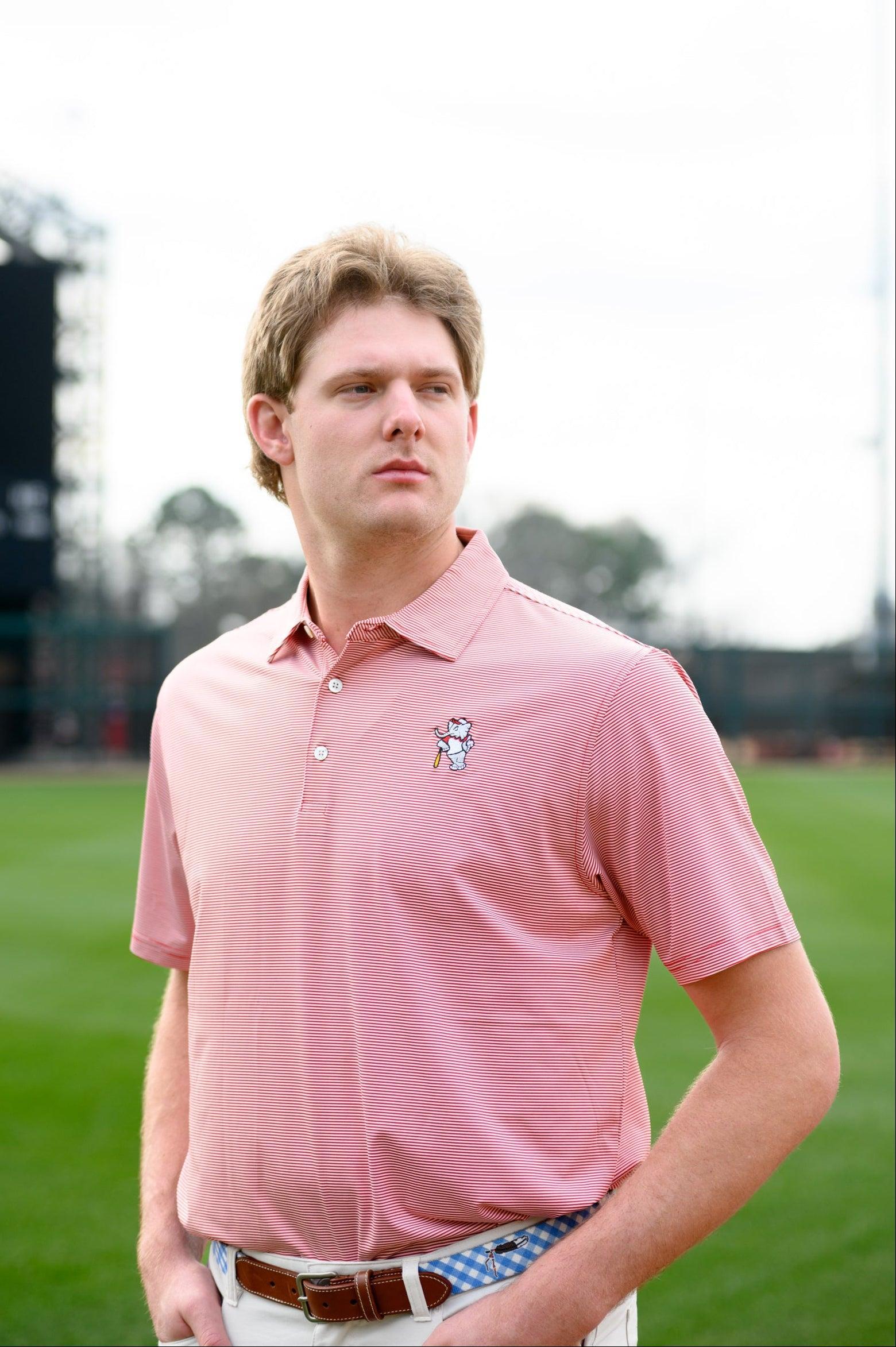 University of Alabama Men's Crimson Stripe Performance Polo with an embroidered image of Big Al in a baseball uniform leaning on a baseball bat
