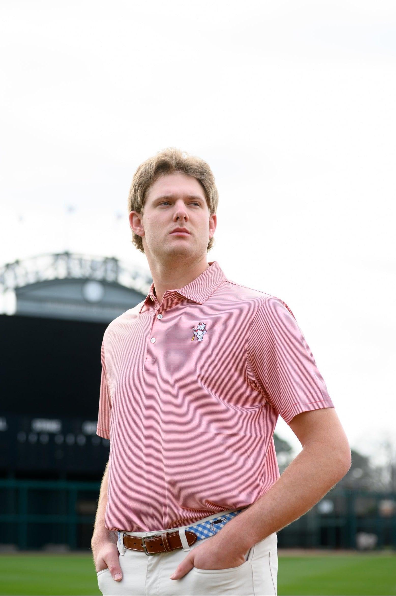 University of Alabama Men's Crimson Stripe Performance Polo with an embroidered image of Big Al in a baseball uniform leaning on a baseball bat