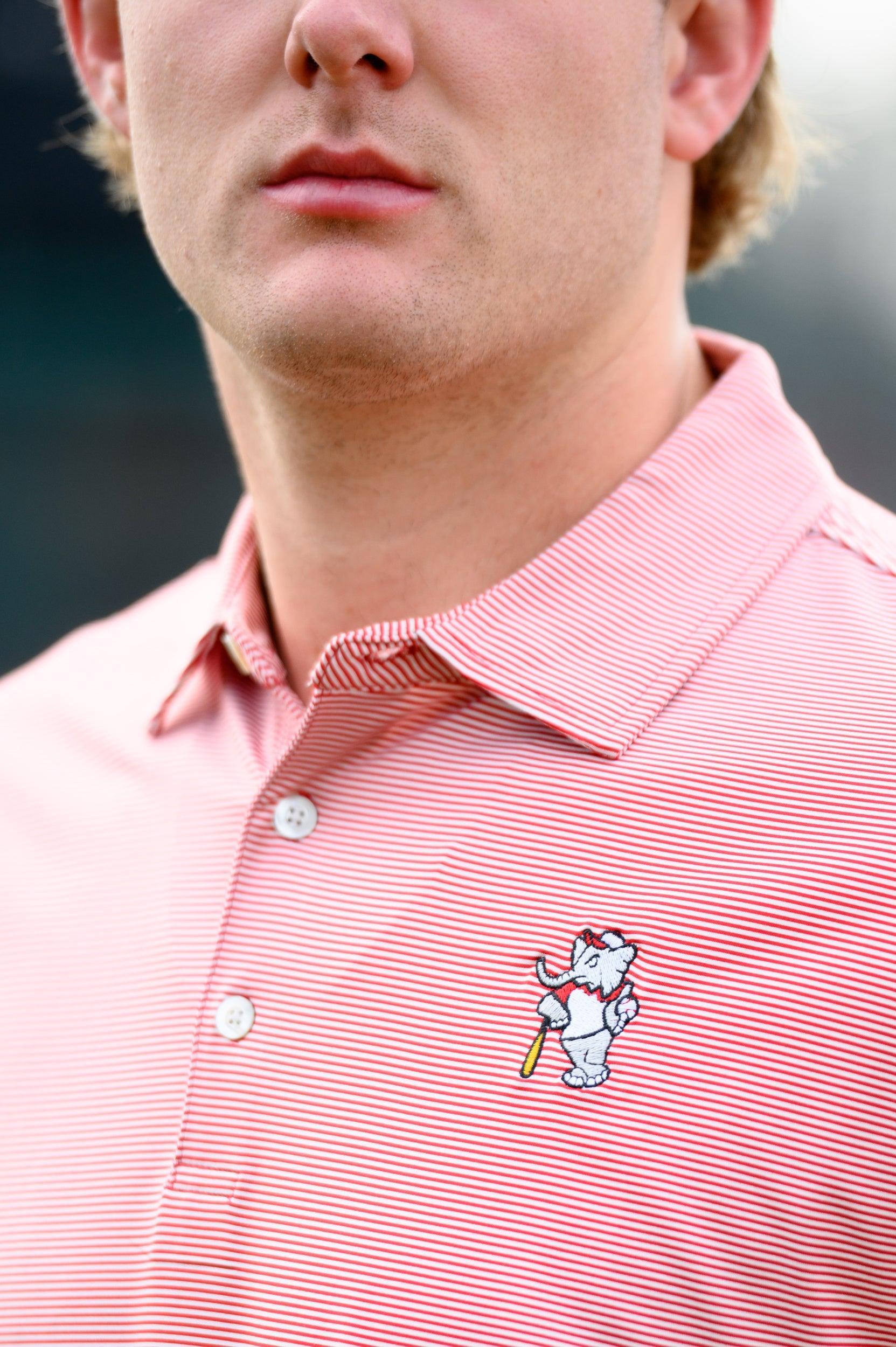 University of Alabama Men's Crimson Stripe Performance Polo with an embroidered image of Big Al in a baseball uniform leaning on a baseball bat