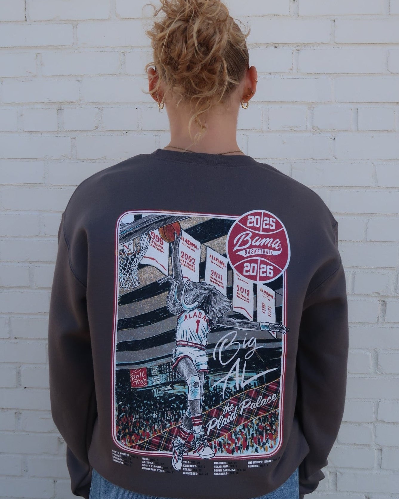 University of Alabama Dark Grey Sweatshirt with an illustration of Big Al dunking a basketball next to text “Big Al” and “the Plaid Palace” above the 2025 Basketball Schedule