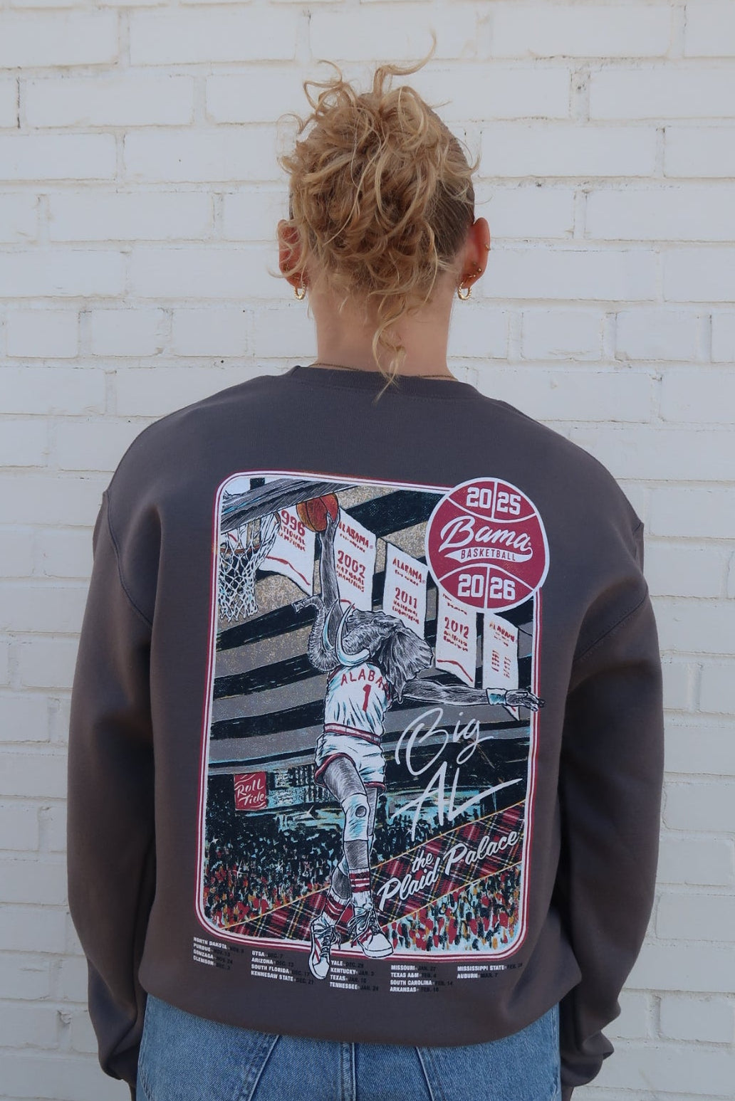 University of Alabama Dark Grey Sweatshirt with an illustration of Big Al dunking a basketball next to text “Big Al” and “the Plaid Palace” above the 2025 Basketball Schedule