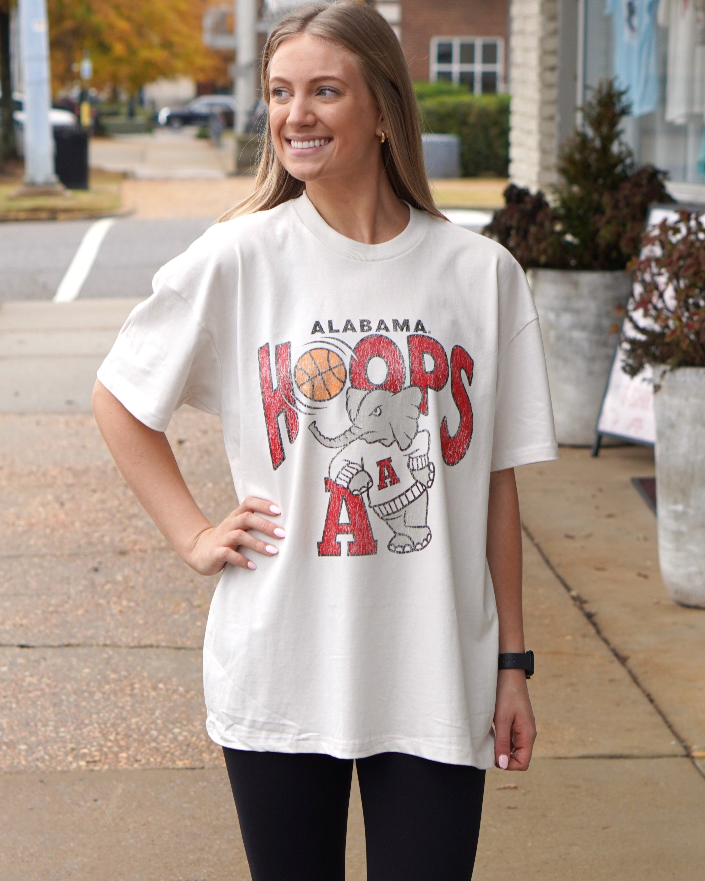 University of Alabama Off-White T-Shirt with Text "Hoops" with a basketball replacing the first "O" above Big Al leaning on a Block A