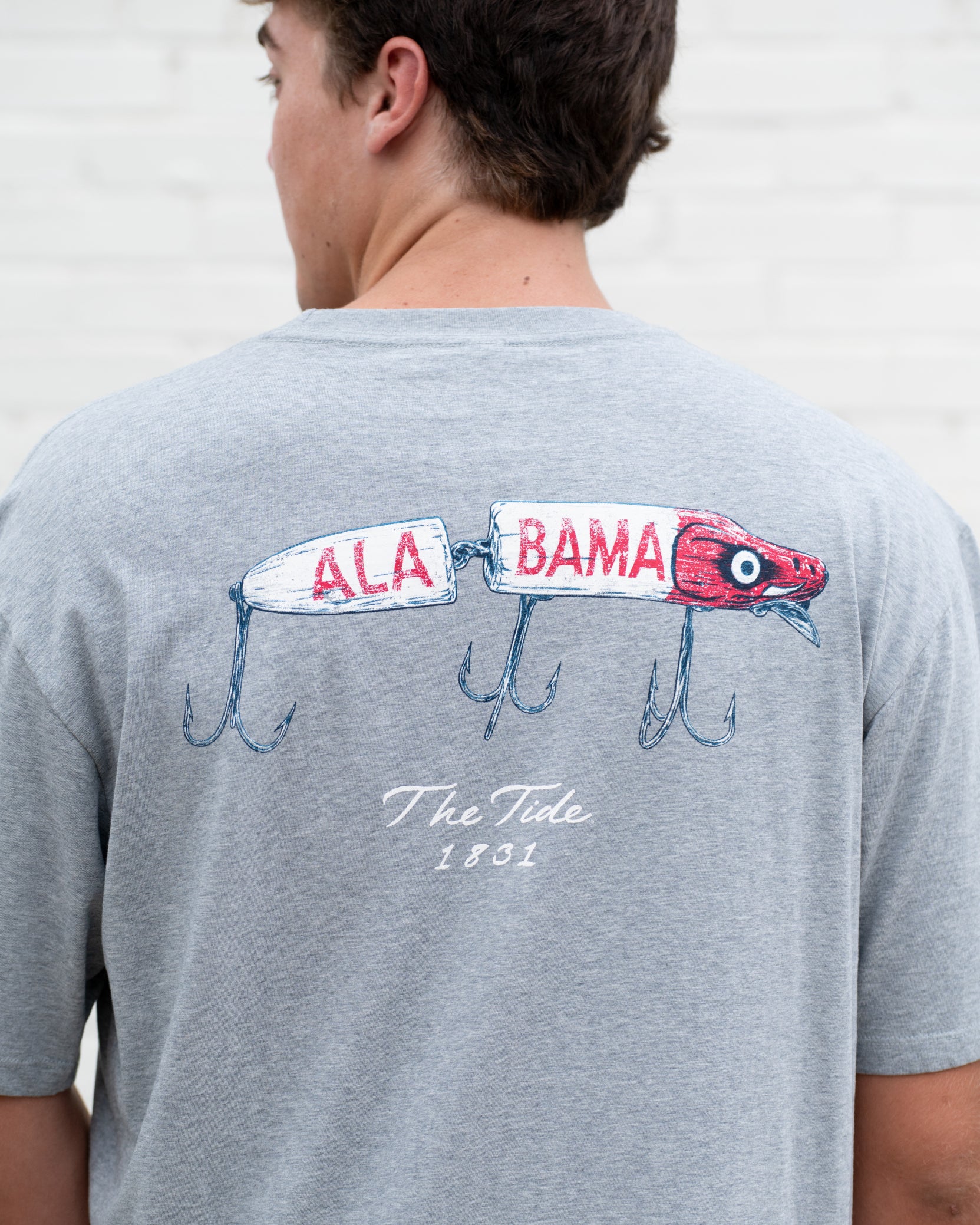 University of Alabama Gray T-Shirt with an image of a fishing lure with Red text "Alabama" above White text “The Tide 1831”