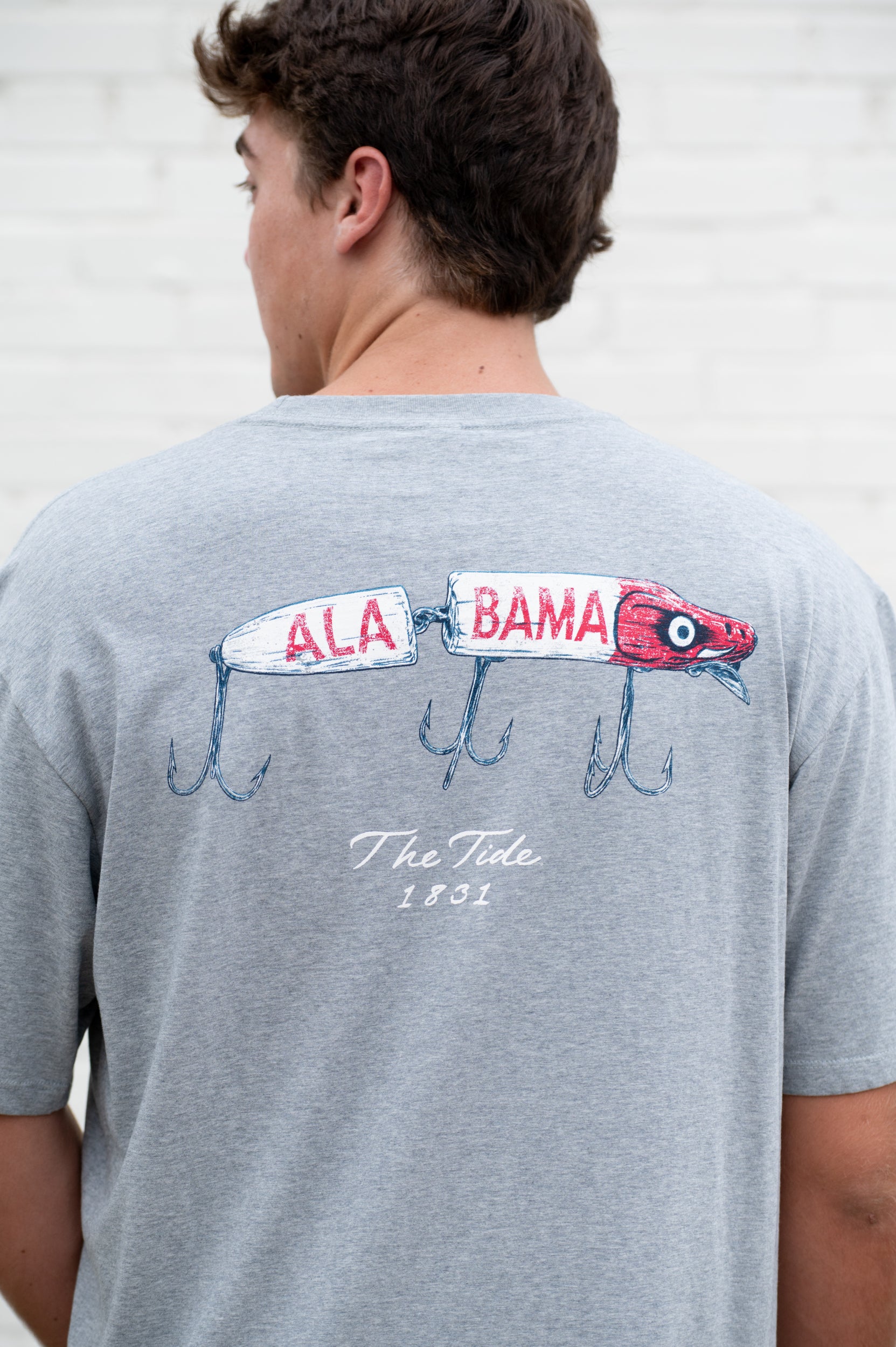 University of Alabama Gray T-Shirt with an image of a fishing lure with Red text "Alabama" above White text “The Tide 1831”