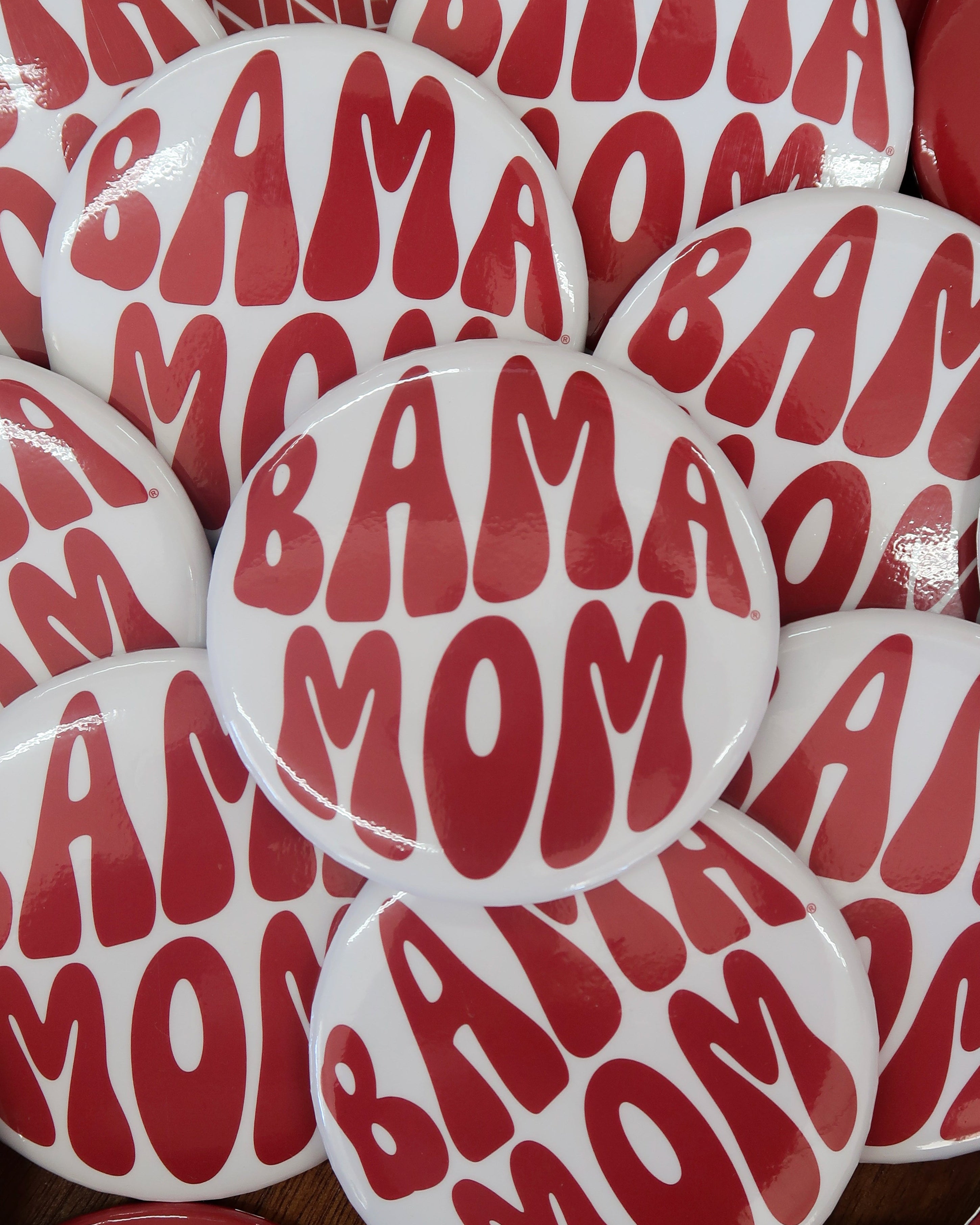 University of Alabama White Button with Red bubble letters that spell “Bama Mom”