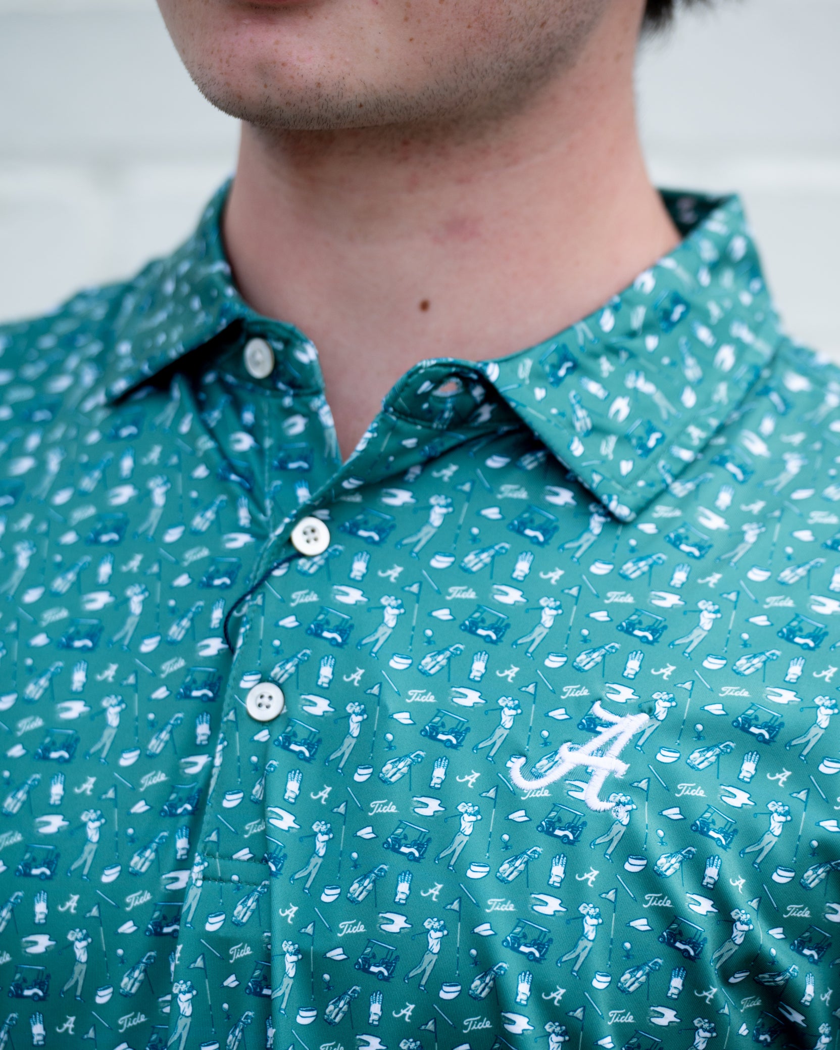 University of Alabama Green Men’s Polo with an Alabama golf-themed pattern and Silver Script A Logo embroidery