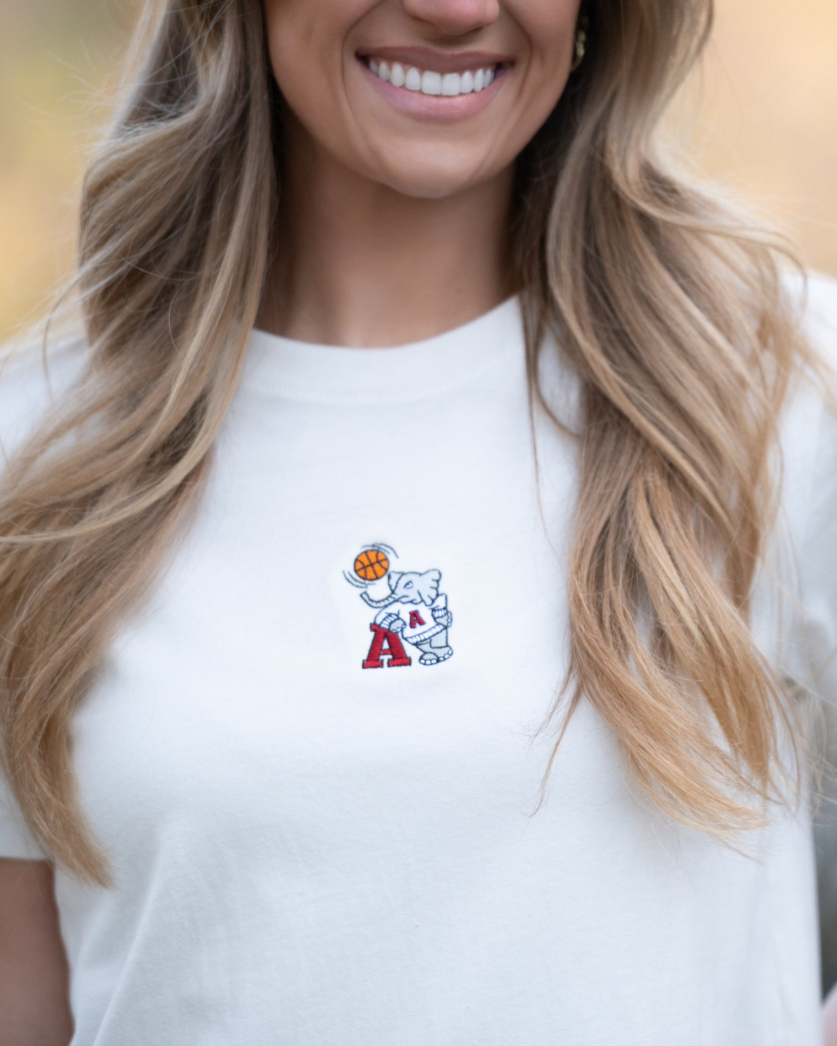 University of Alabama Off-White Ladies Short Sleeve T-Shirt with the Basketball Al Logo embroidered on the middle of the chest