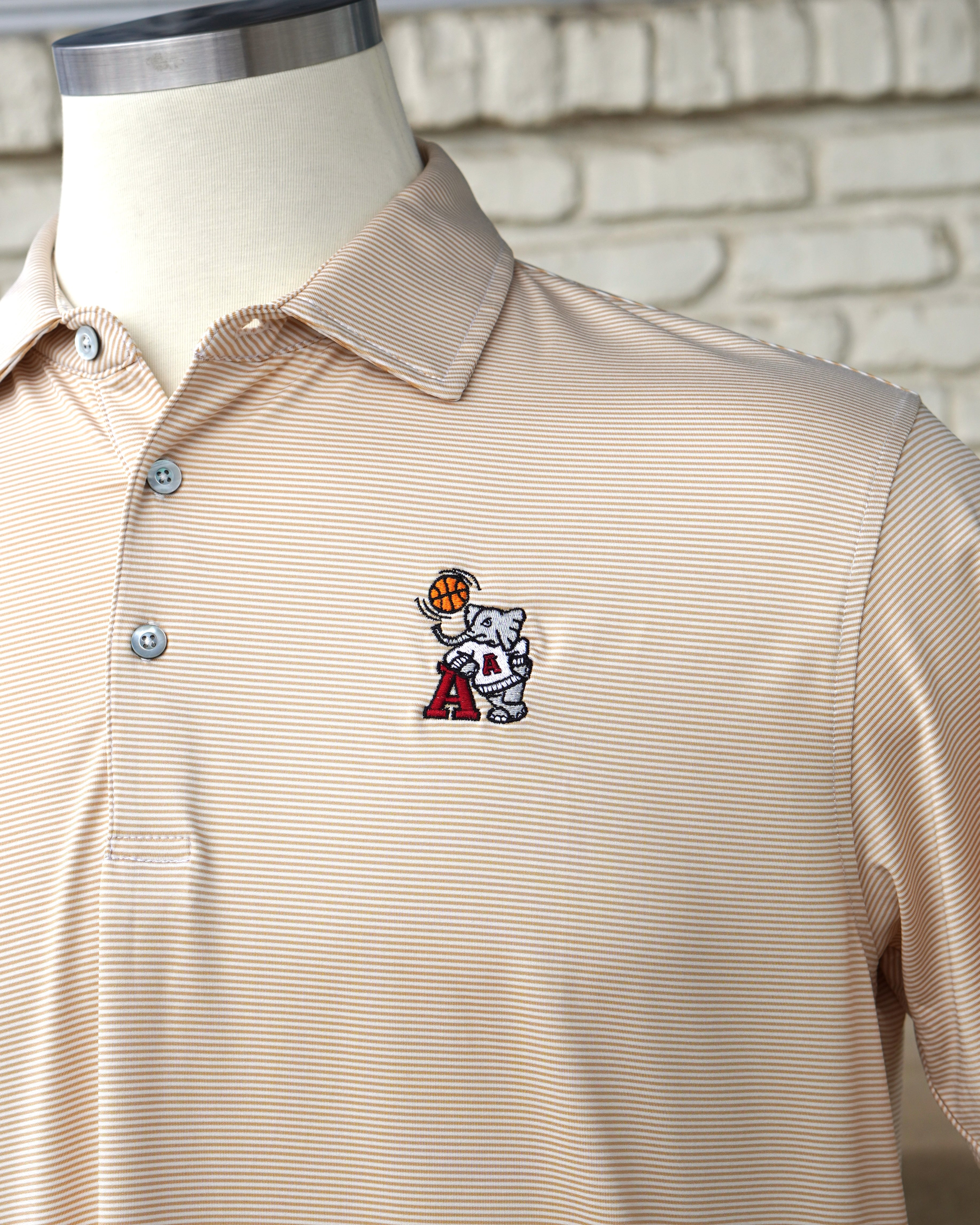 University of Alabama Basketball Al Tan Men’s Polo with an embroidered Big Al in a sweater holding a basketball and leaning against an "A"