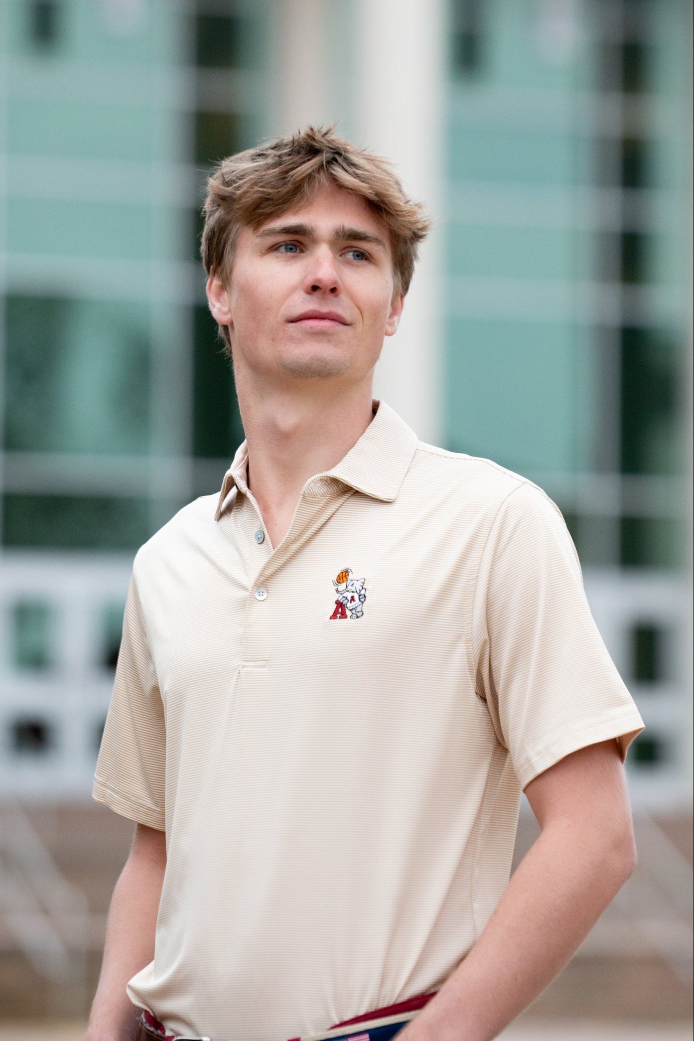 University of Alabama Basketball Al Tan Men’s Polo with an embroidered Big Al in a sweater holding a basketball and leaning against an "A"