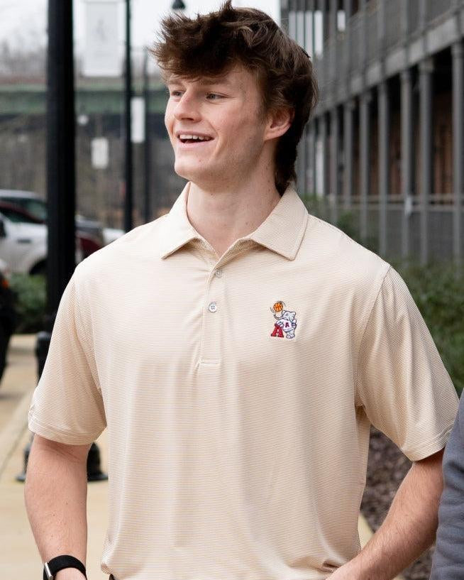 University of Alabama Basketball Al Tan Men’s Polo with an embroidered Big Al in a sweater holding a basketball and leaning against an "A"