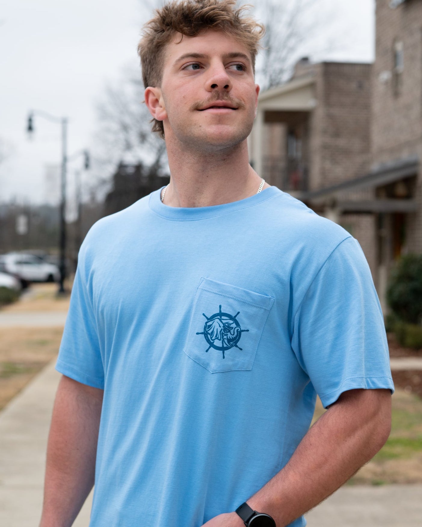 University of Alabama Blue Shirt with a front pocket featuring a ship’s wheel behind a Sailor Big Al design