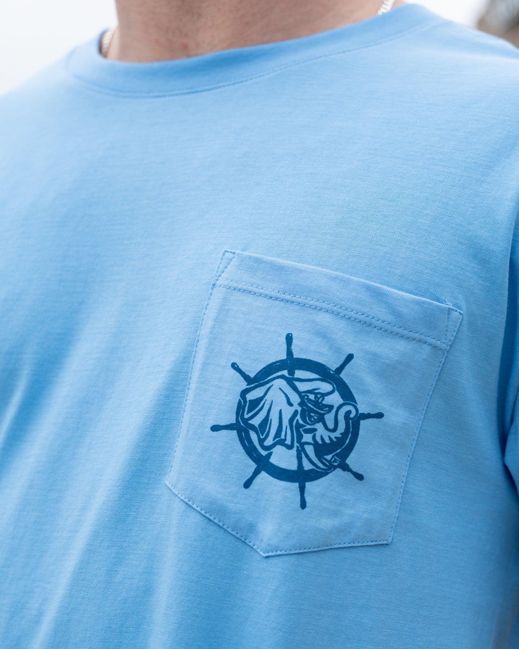 University of Alabama Blue Shirt with a front pocket featuring a ship’s wheel behind a Sailor Big Al design