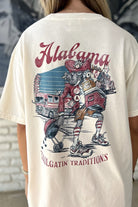 University of Alabama Cream Big Al Tailgate Comfort Colors T-Shirt with an image of Big Al in Gameday Gear with a cooler and a grill above text "Tailgatin' Traditions"