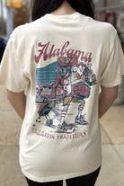 University of Alabama Cream Big Al Tailgate Comfort Colors T-Shirt with an image of Big Al in Gameday Gear with a cooler and a grill above text "Tailgatin' Traditions"