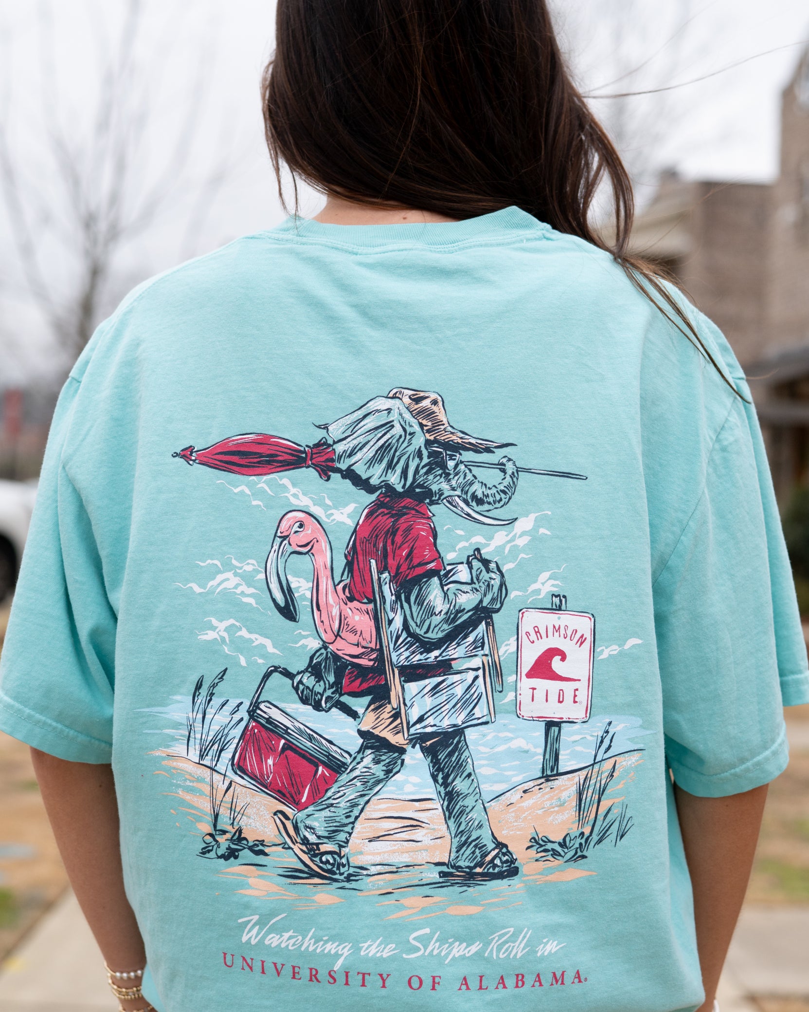 University of Alabama Big Al Beach Chalky Mint Comfort Colors T-Shirt with an image of Big Al in beach clothes carrying an umbrella dragging a cooler across the sand