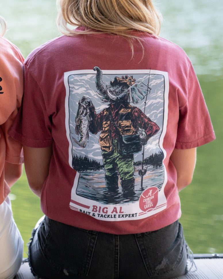 University of Alabama Big Al Fishing Comfort Colors Red T-Shirt with image of Big Al standing in the water holding a fishing pole