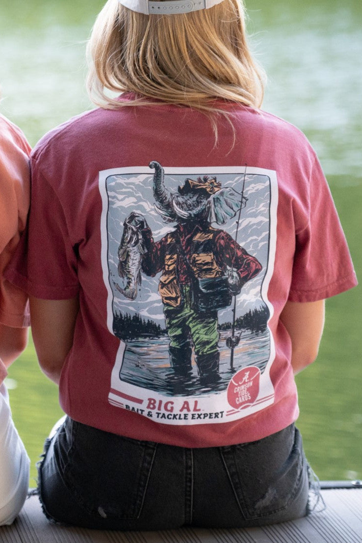 University of Alabama Big Al Fishing Comfort Colors Red T-Shirt with image of Big Al standing in the water holding a fishing pole