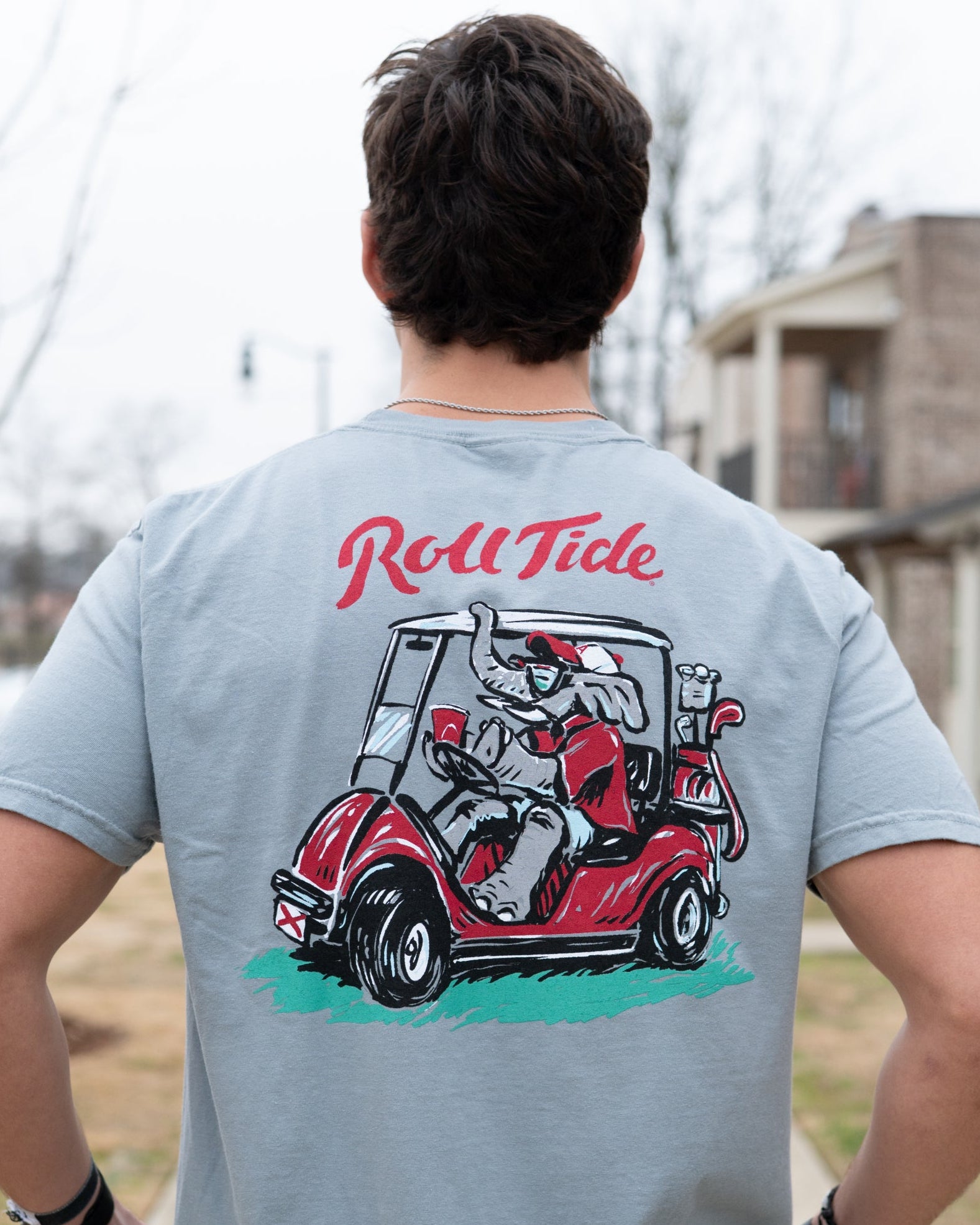 University of Alabama Grey Shirt with the text "Roll Tide" above an image of Big Al wearing sunglasses and driving a golf cart
