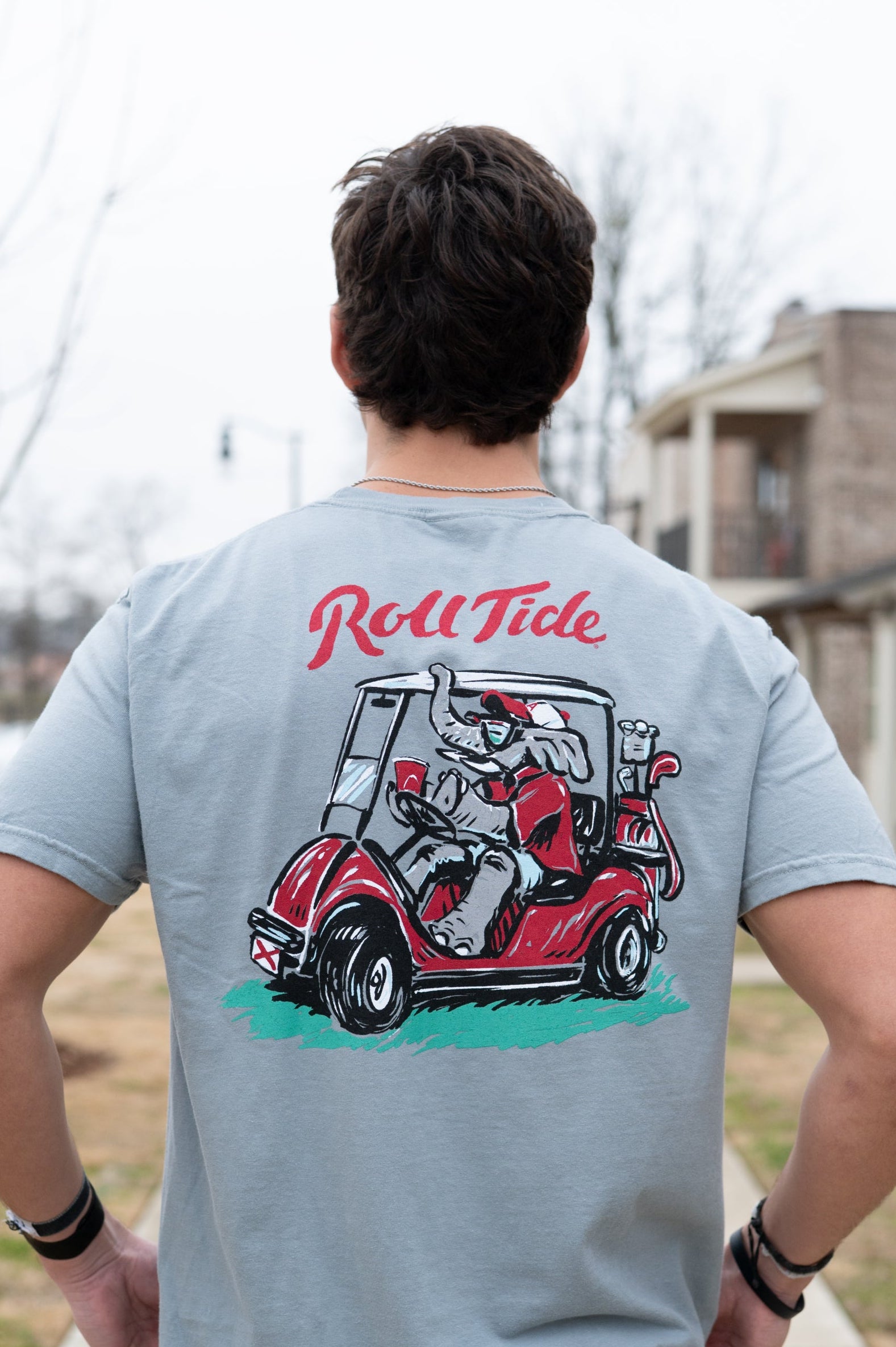 University of Alabama Grey Shirt with the text "Roll Tide" above an image of Big Al wearing sunglasses and driving a golf cart