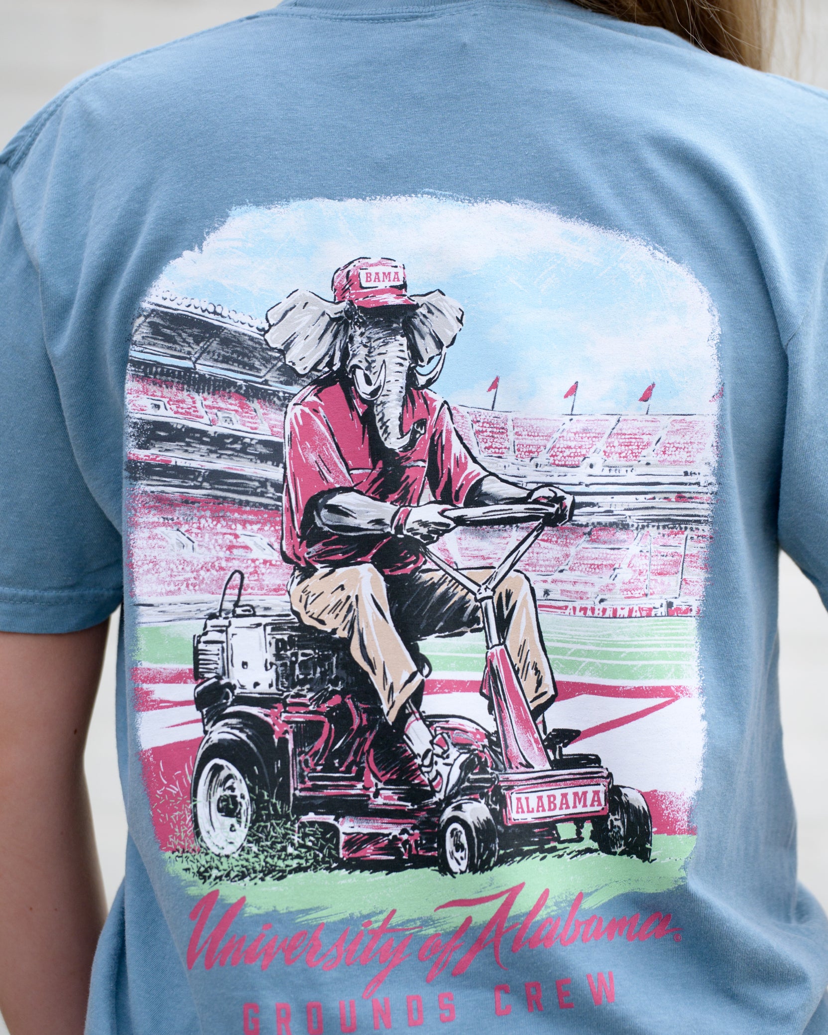 University of Alabama Blue Big Al Grounds Crew T-Shirt with an image of Big Al in a polo and khakis riding a lawnmower