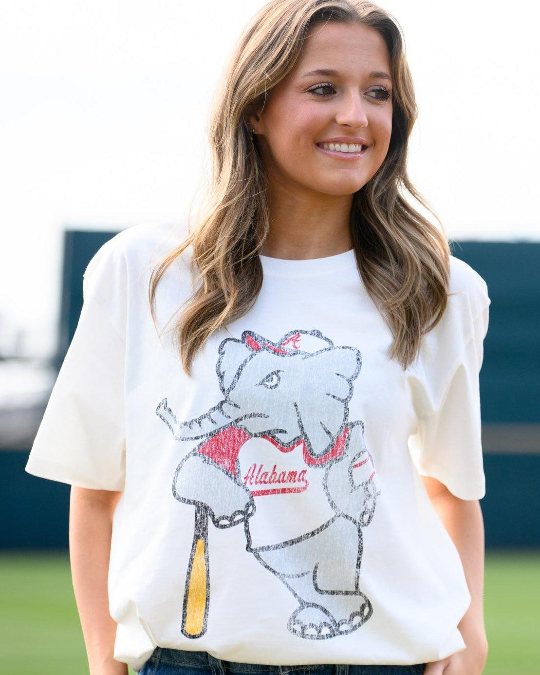 University of Alabama Big Al Vintage Baseball Ivory SoftShirts T-Shirt with an image of a vintage Big Al in a baseball uniform leaning against a baseball bat