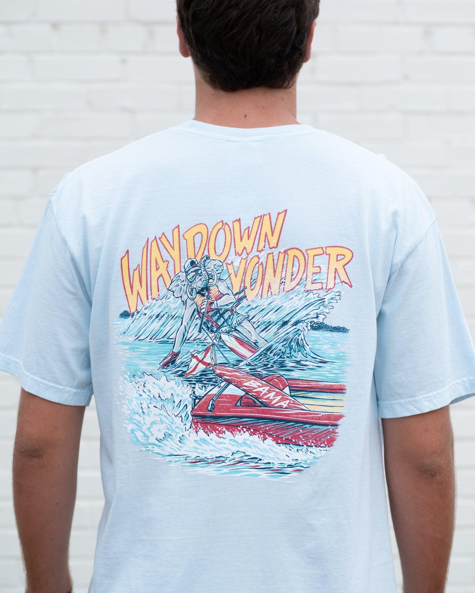 University of Alabama Baby Blue T-Shirt with Yellow text “Way Down Yonder” above an image of Big Al water skiing