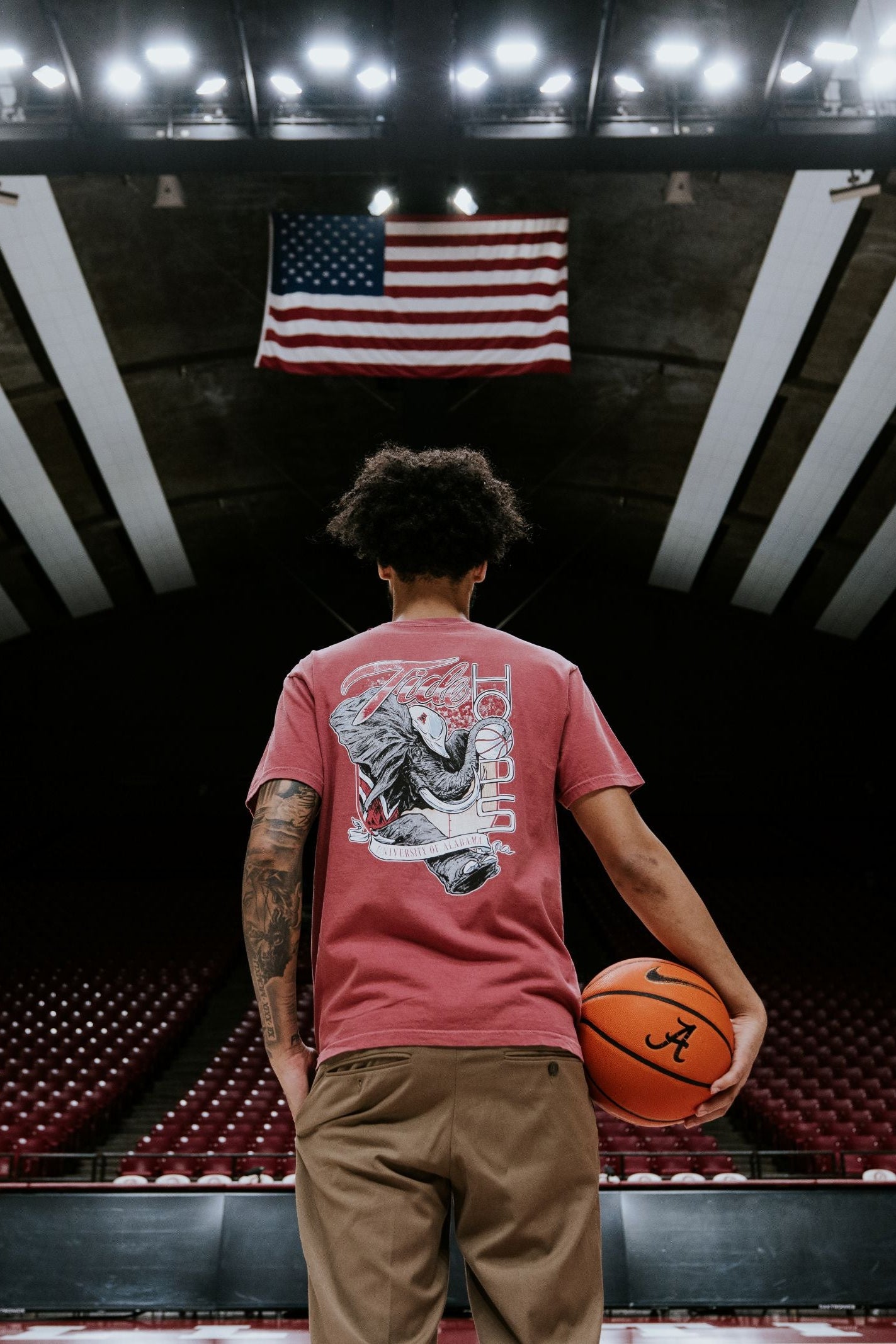 University of Alabama Red T-Shirt with Big Al wearing a hard hat and holding a basketball with his trunk to help spell the word “Hoops”