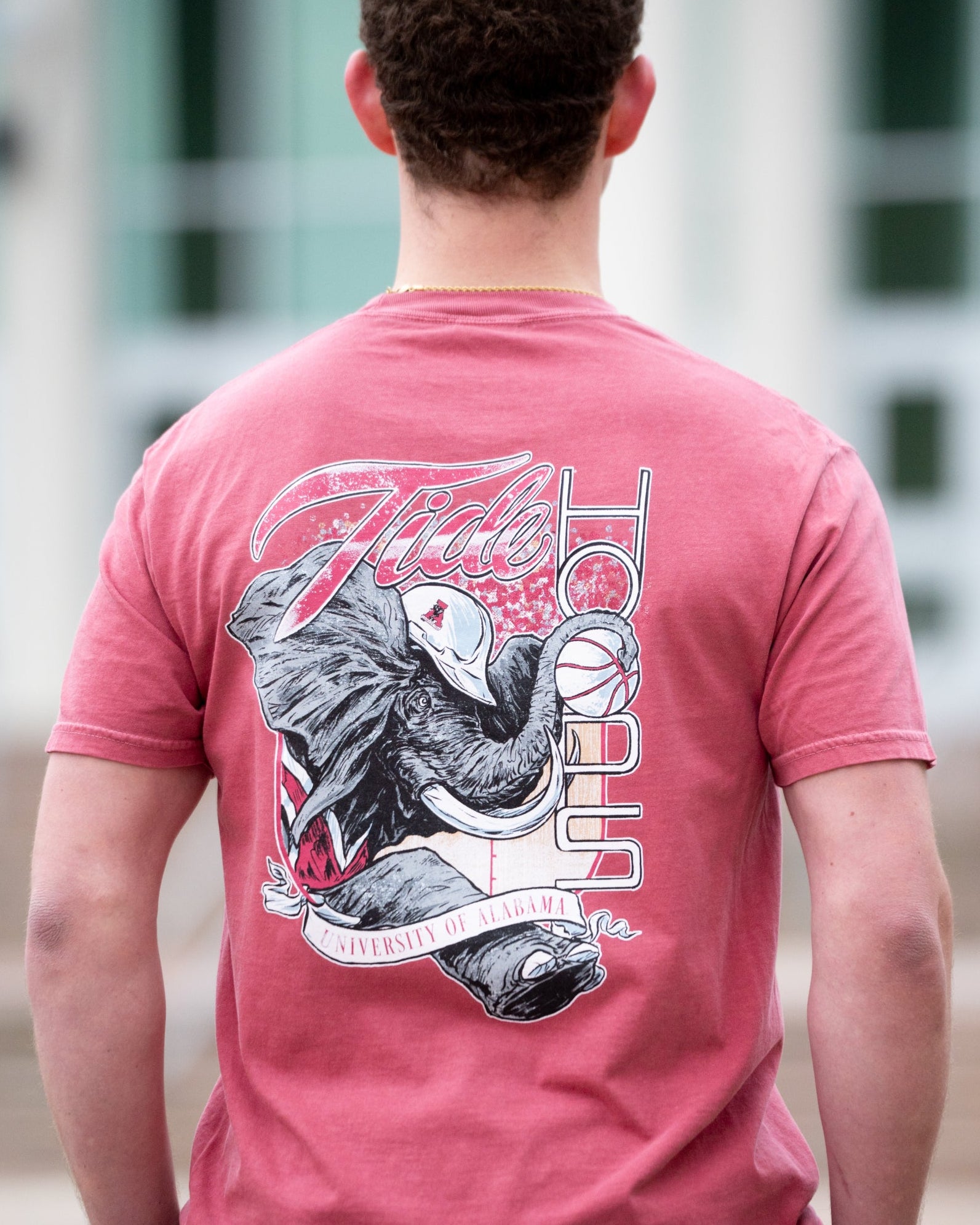 University of Alabama Red T-Shirt with Big Al wearing a hard hat and holding a basketball with his trunk to help spell the word “Hoops”