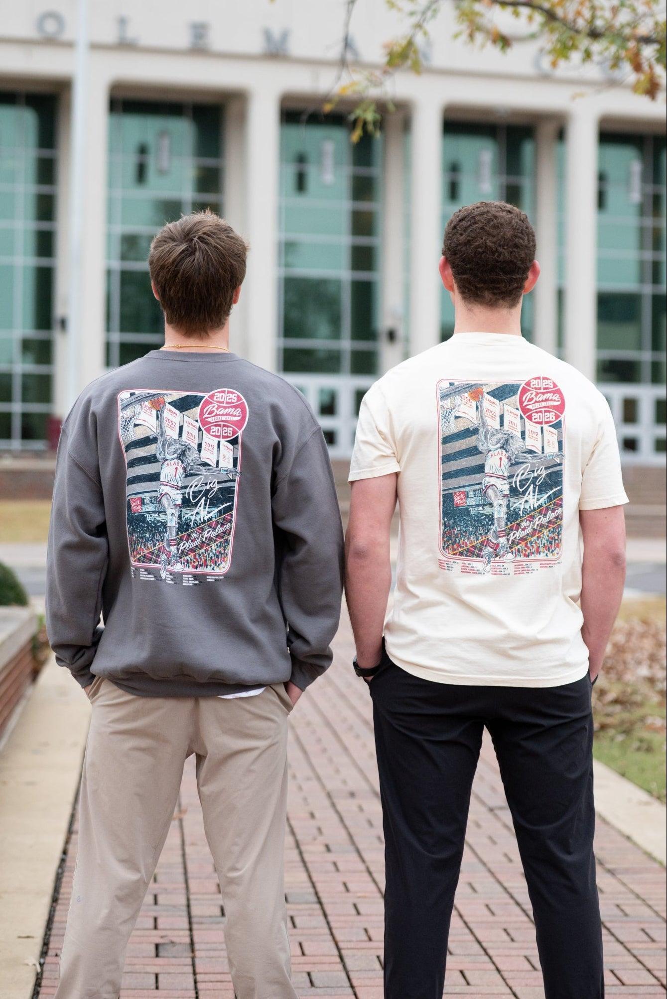Two people wearing sweatshirts with stadium graphics outdoors.