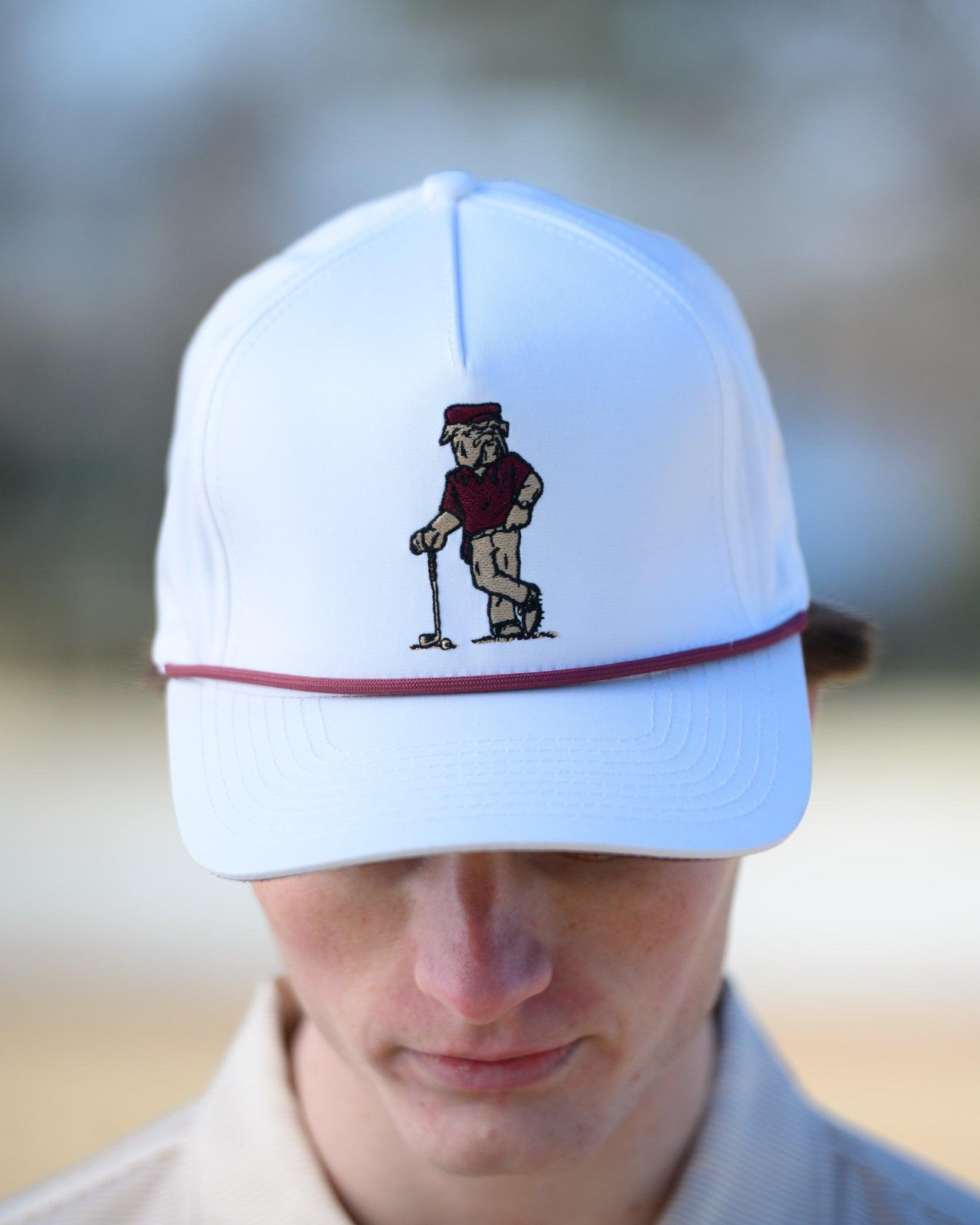 Mississippi State White Hat with an image of Bully leaning against a golf club