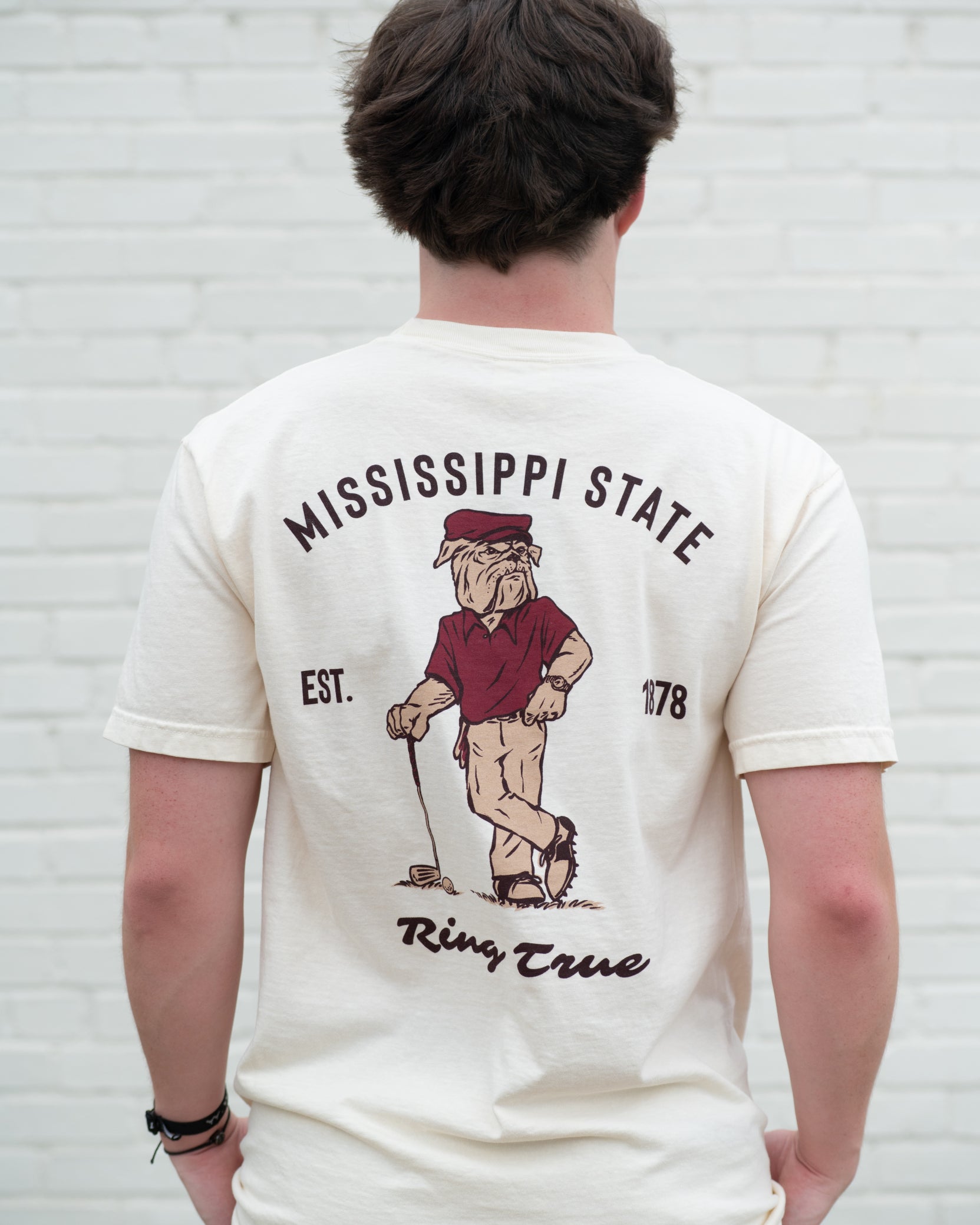 Mississippi State Ivory T-Shirt with an image of Bully leaning against a golf club between Maroon Text "Mississippi State" and "Ring True"