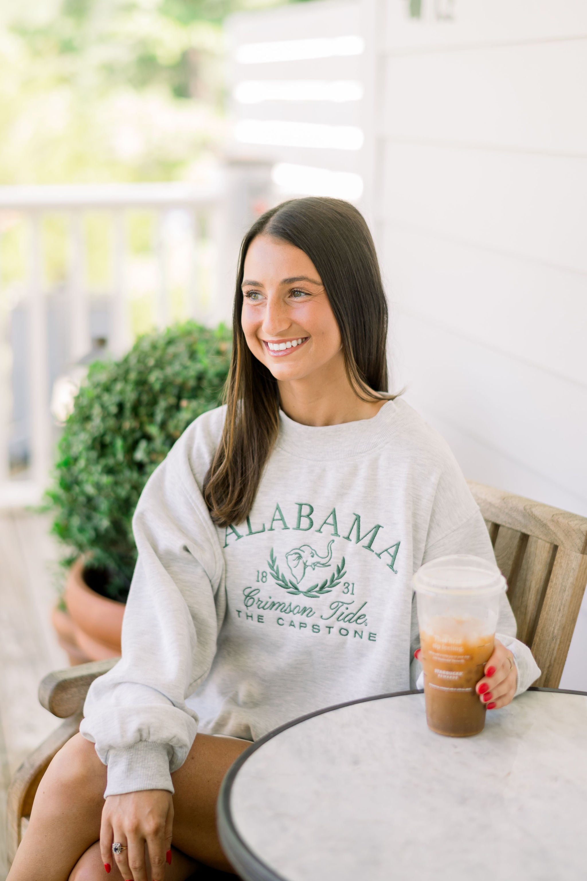 University of Alabama Grey Mock Neck Sweatshirt with Green Embroidered text “Alabama” above the elephant crest (An elephant head outline encircled by a wreath of laurels), and text “Crimson Tide- The Capstone”