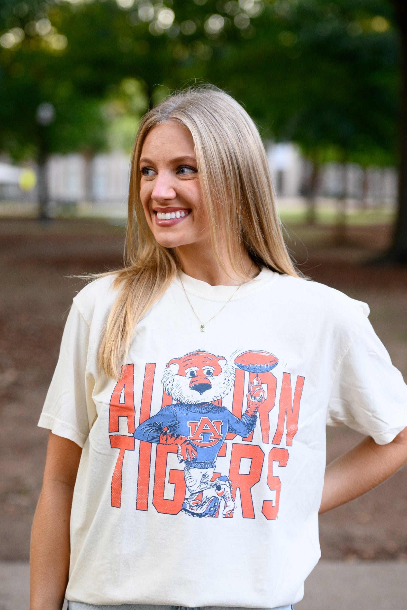 Auburn University Cream Chill Aubie Comfort Colors T-Shirt with Orange text "Auburn Tigers" and a graphic of Aubie leaning against the "G" of "Tigers"