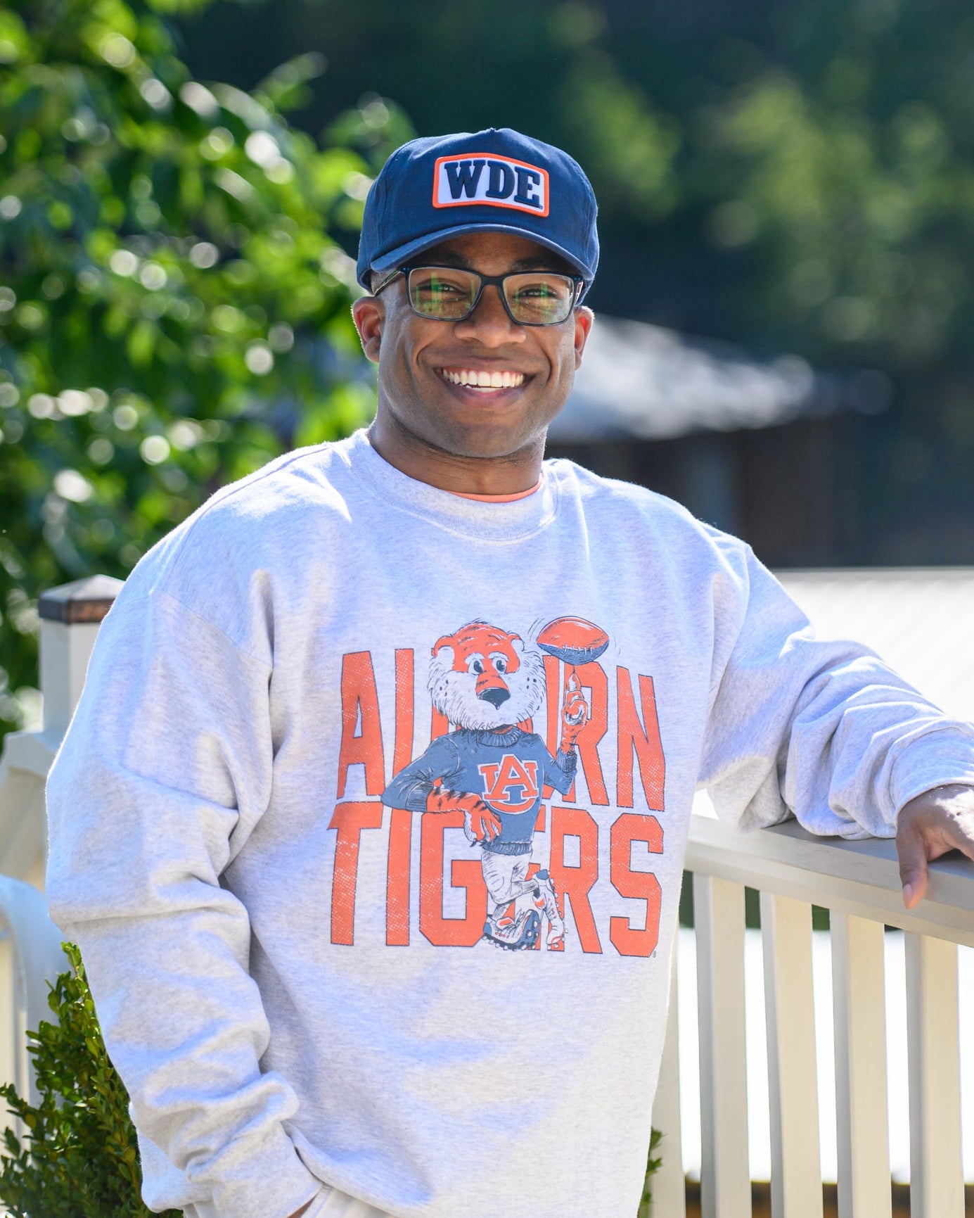 Auburn University Cream Chill Aubie Comfort Colors T-Shirt with Orange text "Auburn Tigers" and a graphic of Aubie leaning against the "G" of "Tigers"