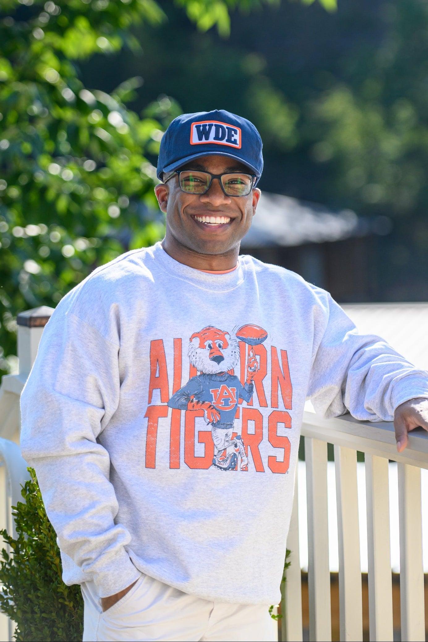 Auburn University Cream Chill Aubie Comfort Colors T-Shirt with Orange text "Auburn Tigers" and a graphic of Aubie leaning against the "G" of "Tigers"