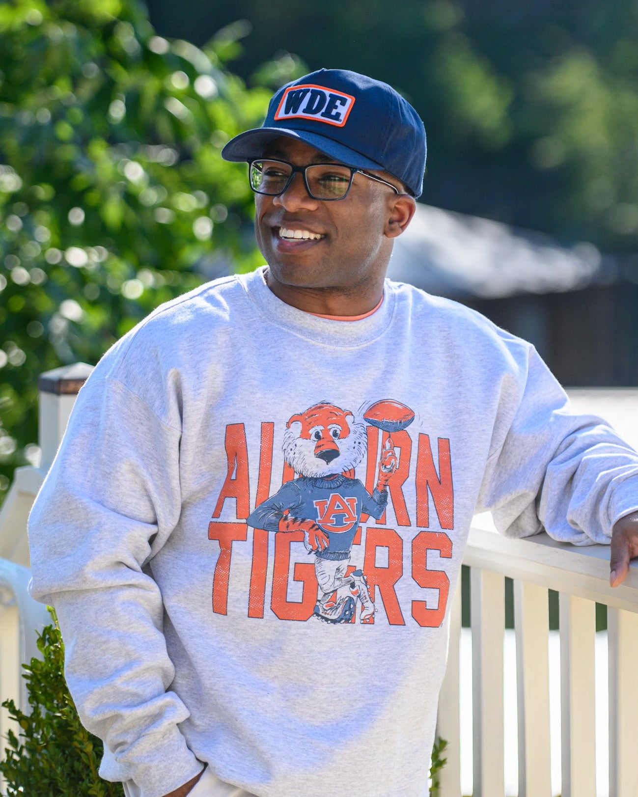 Auburn University Cream Chill Aubie Comfort Colors T-Shirt with Orange text "Auburn Tigers" and a graphic of Aubie leaning against the "G" of "Tigers"