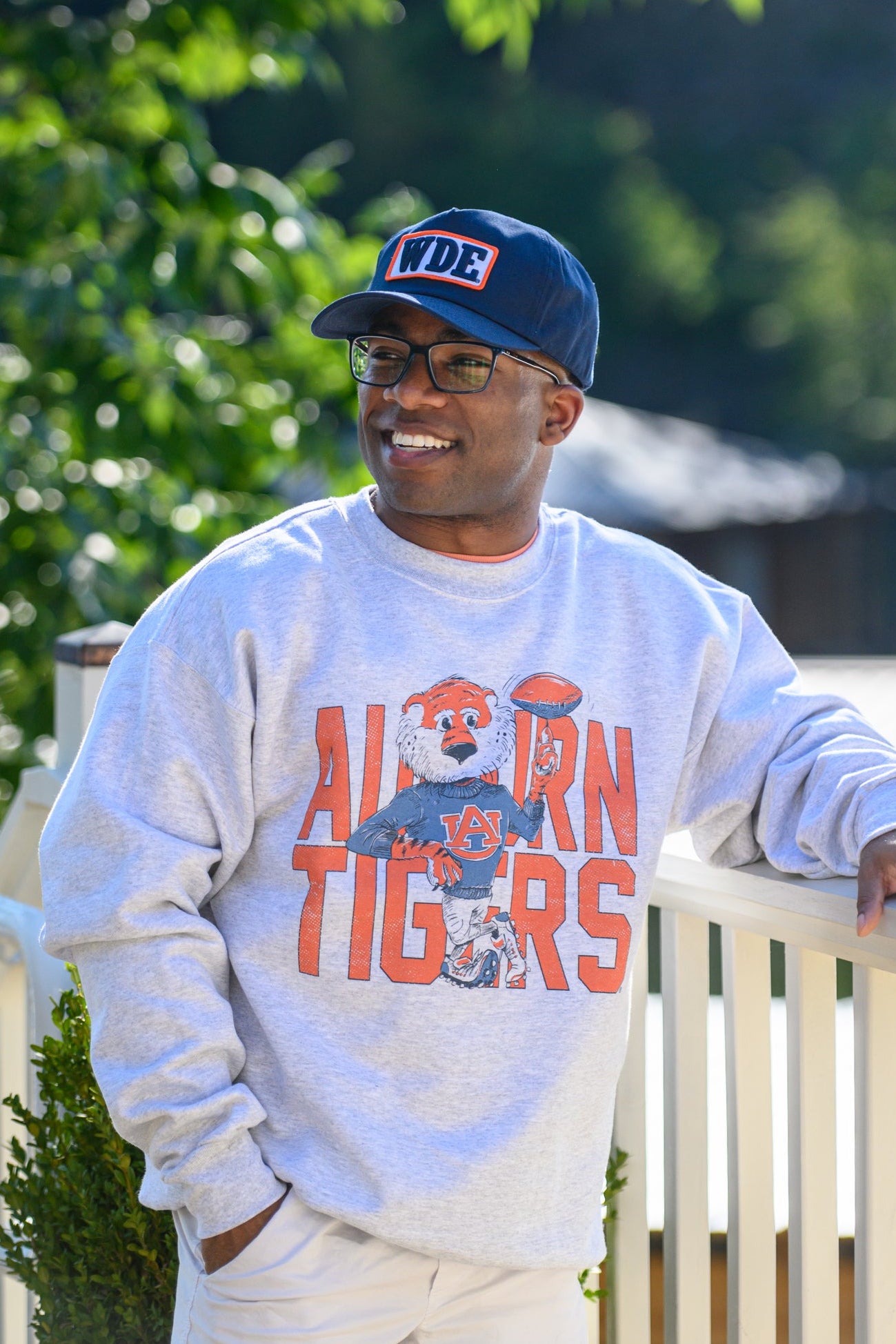 Auburn University Cream Chill Aubie Comfort Colors T-Shirt with Orange text "Auburn Tigers" and a graphic of Aubie leaning against the "G" of "Tigers"