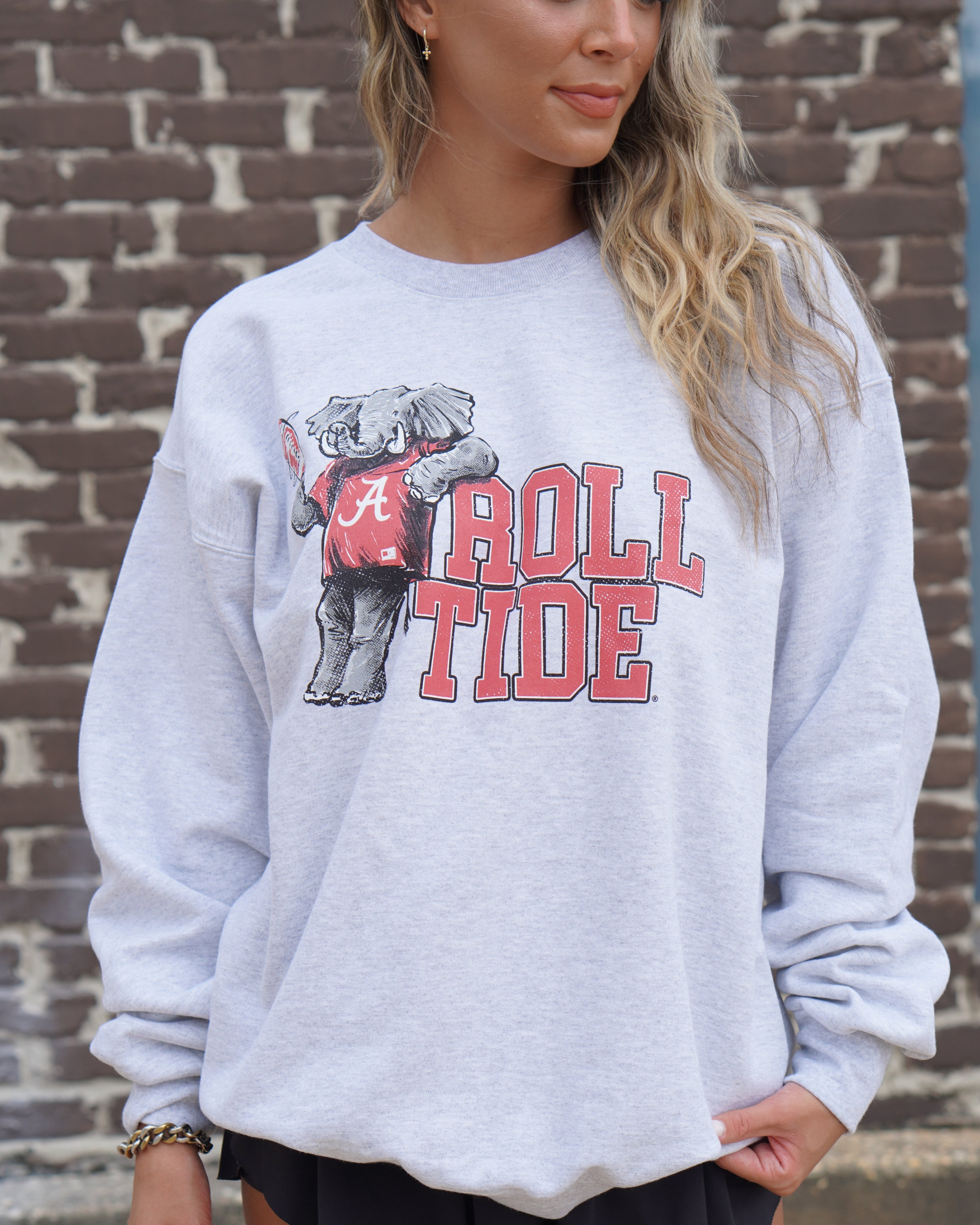 University of Alabama Gray Chill Big Al Sweatshirt with Red text "Roll Tide" and a graphic of Big Al leaning against the "R" of "Roll"